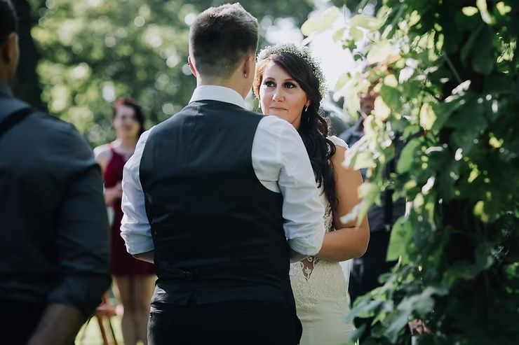 same sex couple sharing moment during wedding ceremony at diamond oak events in iowa