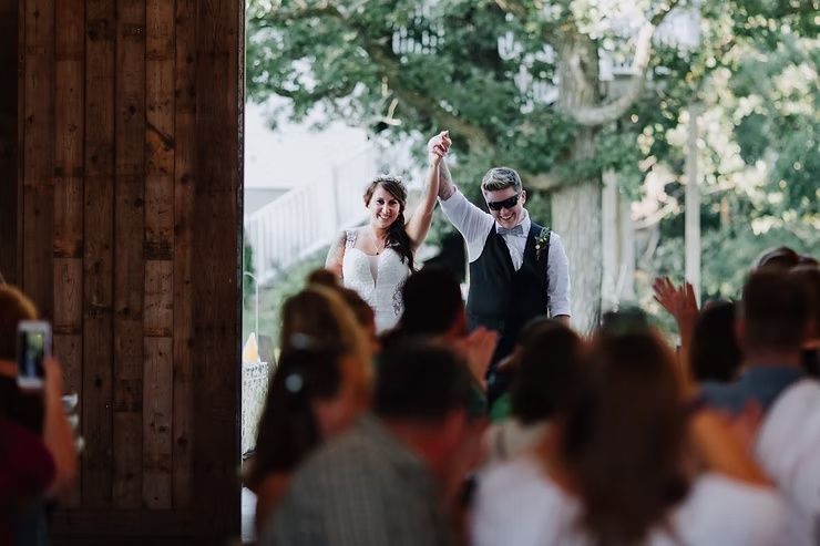lgbtq couple entering reception in clear lake, iowa baarn wedding