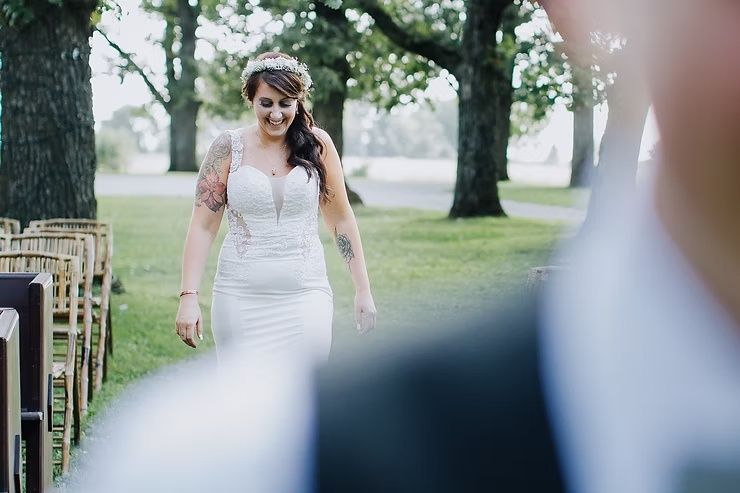 bride walking up to same sex groom during first look on wedding day