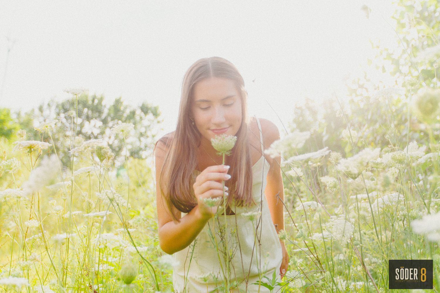 high school senior girl smelling flowers in a prairie near charles city, iowa - soder 8