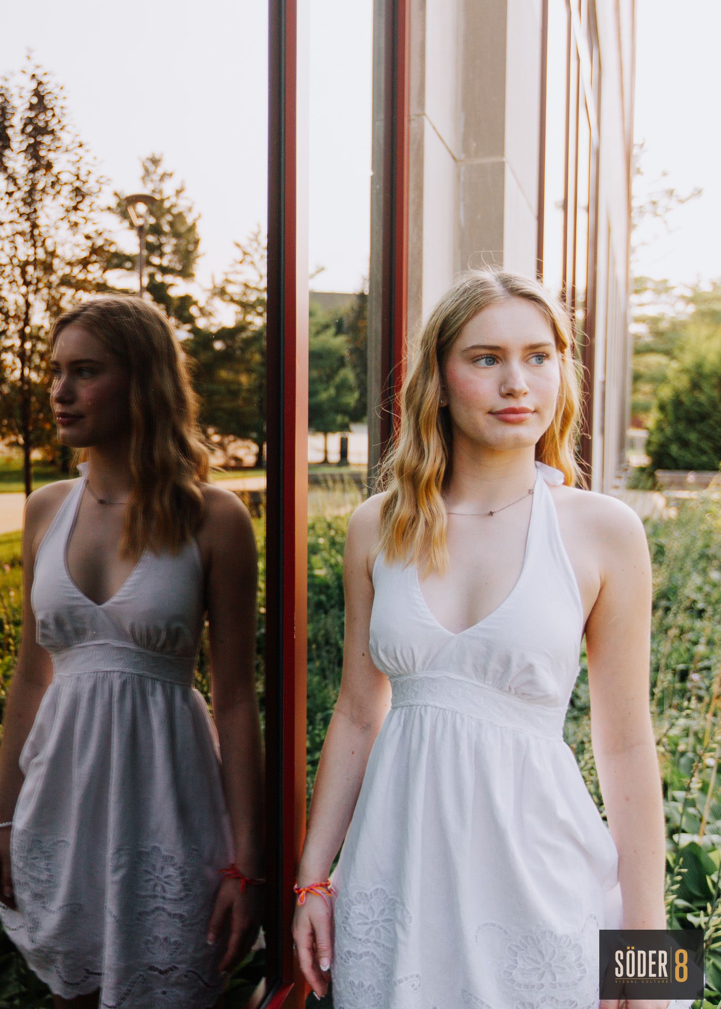 high school girl portrait next to reflective window