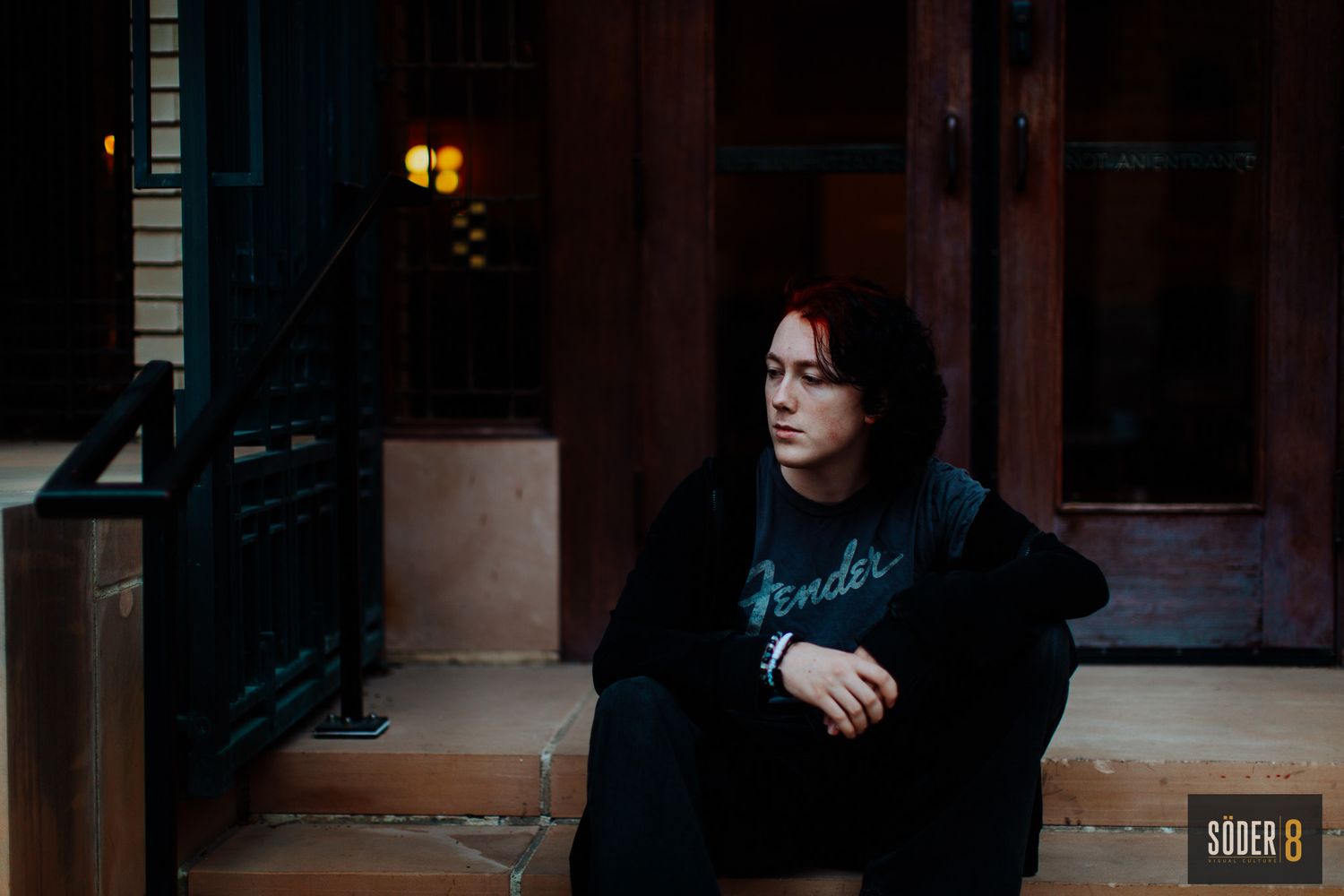high school senior boy sitting on steps at dusk in mason city, Iowa - SODER 8