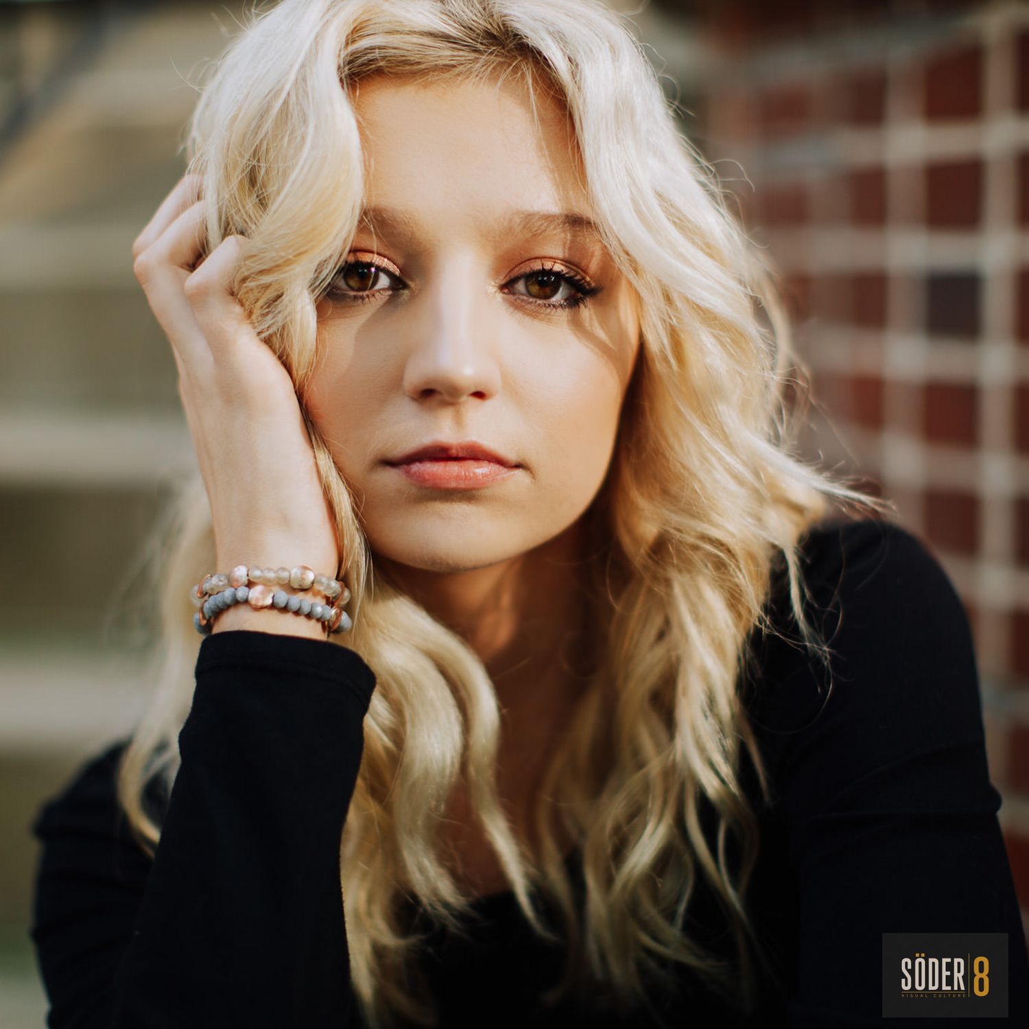 high school senior girl resting her head on her hands in soft light - mason city, iowa - SODER 8