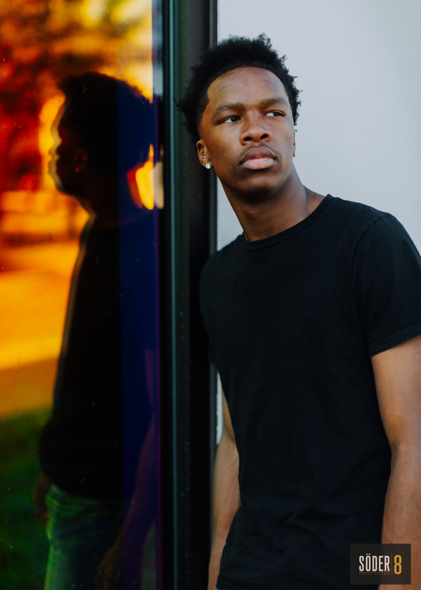 high school senior near reflective glass