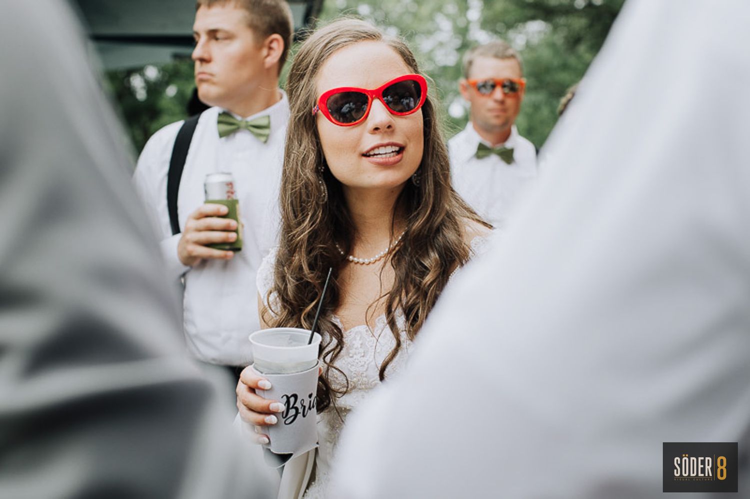 bride in red sunglasses at reception