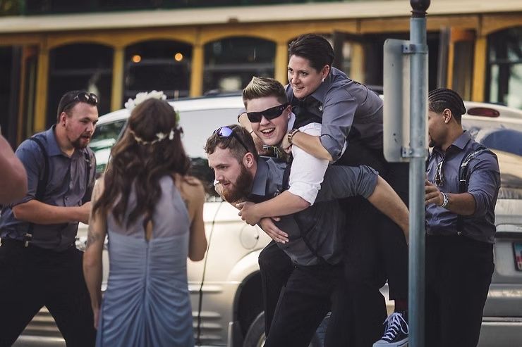 LGBTIQQ groom partying with friends after wedding ceremony at diamond oak events in clear lake, iowa