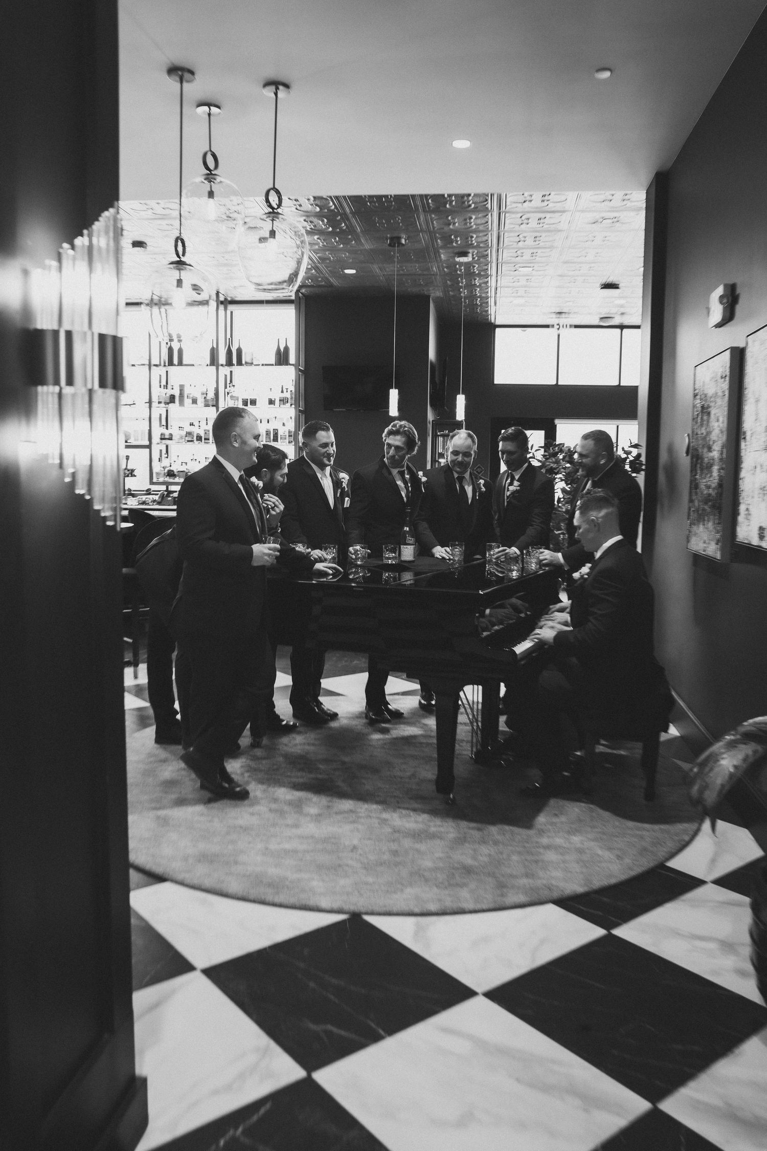 Vintage black and white photograph of a lounge area with checkered floor pattern and people sitting in a waiting area.