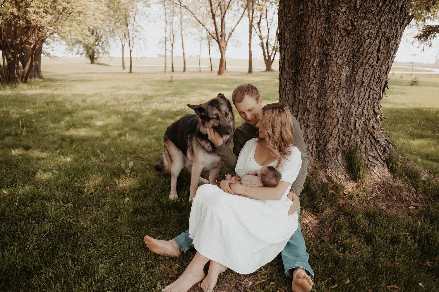 newborn with dog and family