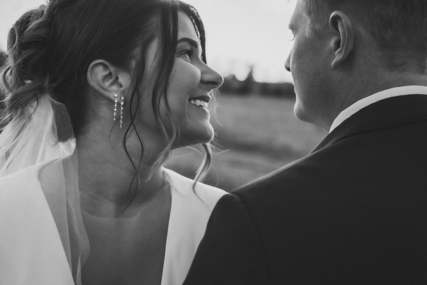 A black and white photo montage showing intimate wedding moments between a couple in romantic poses.