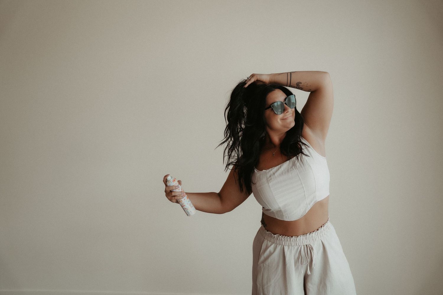 A series of ethereal bridal portraits featuring a flowing white dress against a neutral backdrop.