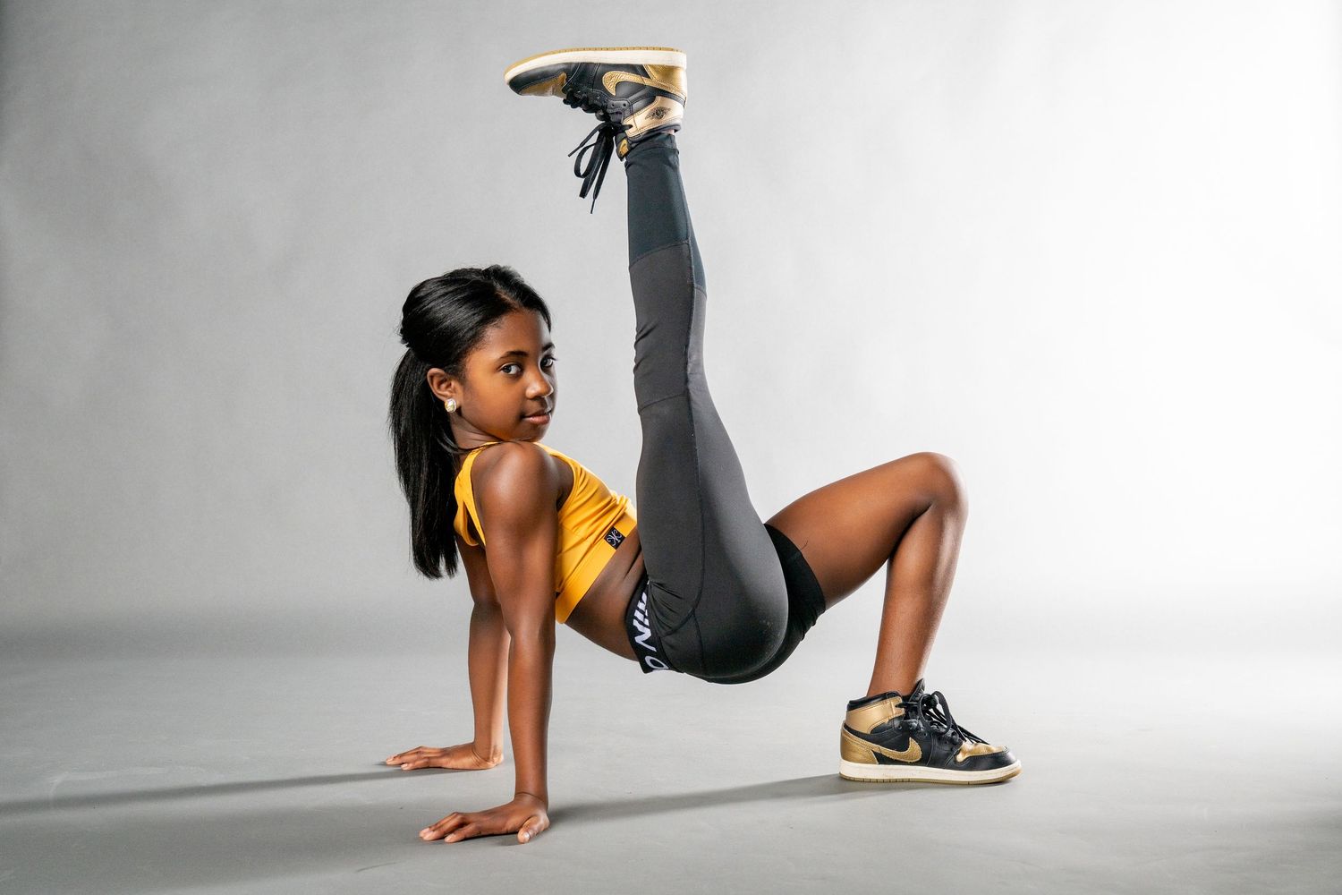 A sequence of dance movements shows a person in yellow performing dynamic floor-based choreography.