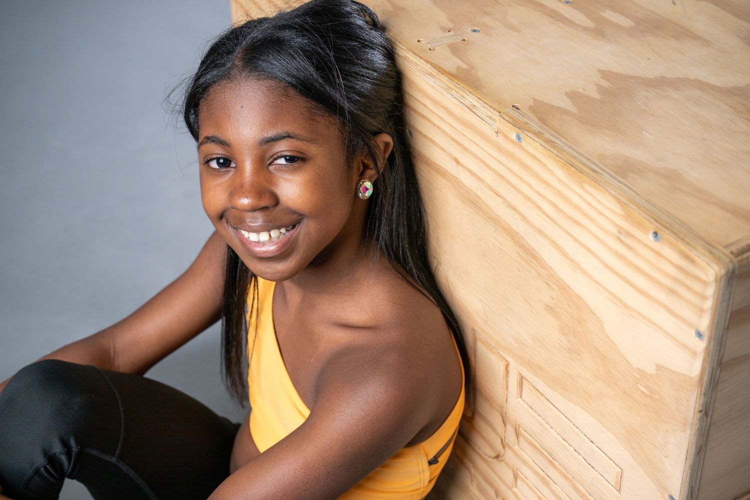 Studio portrait series showing joyful expressions and natural poses against neutral backdrop.