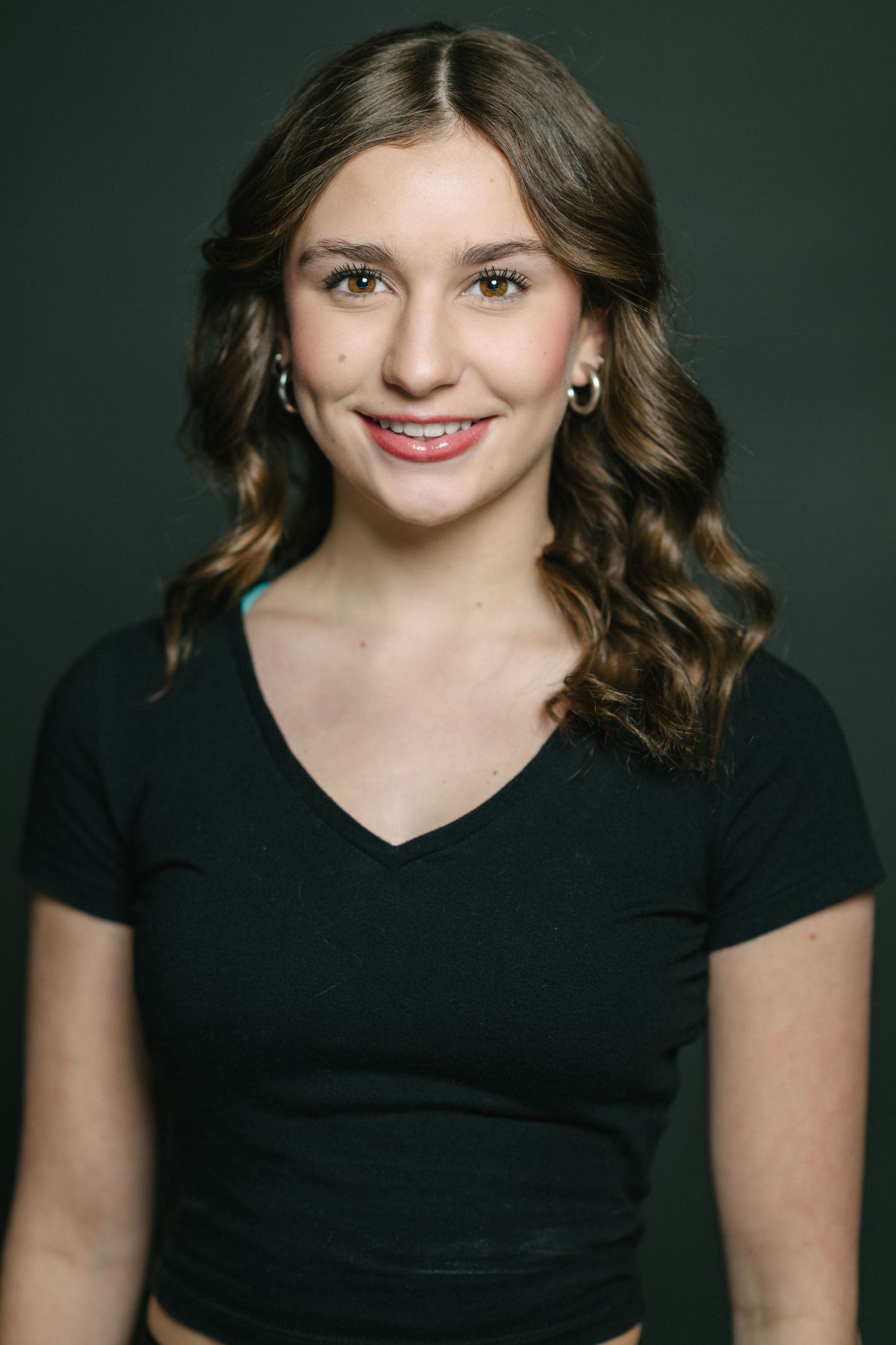 A series of headshots showing someone in a black shirt against a dark background with warm lighting and natural expressions.