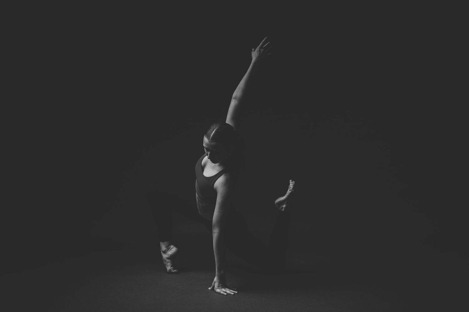 Black and white photo sequence showing a gymnast performing a back handspring on a balance beam.