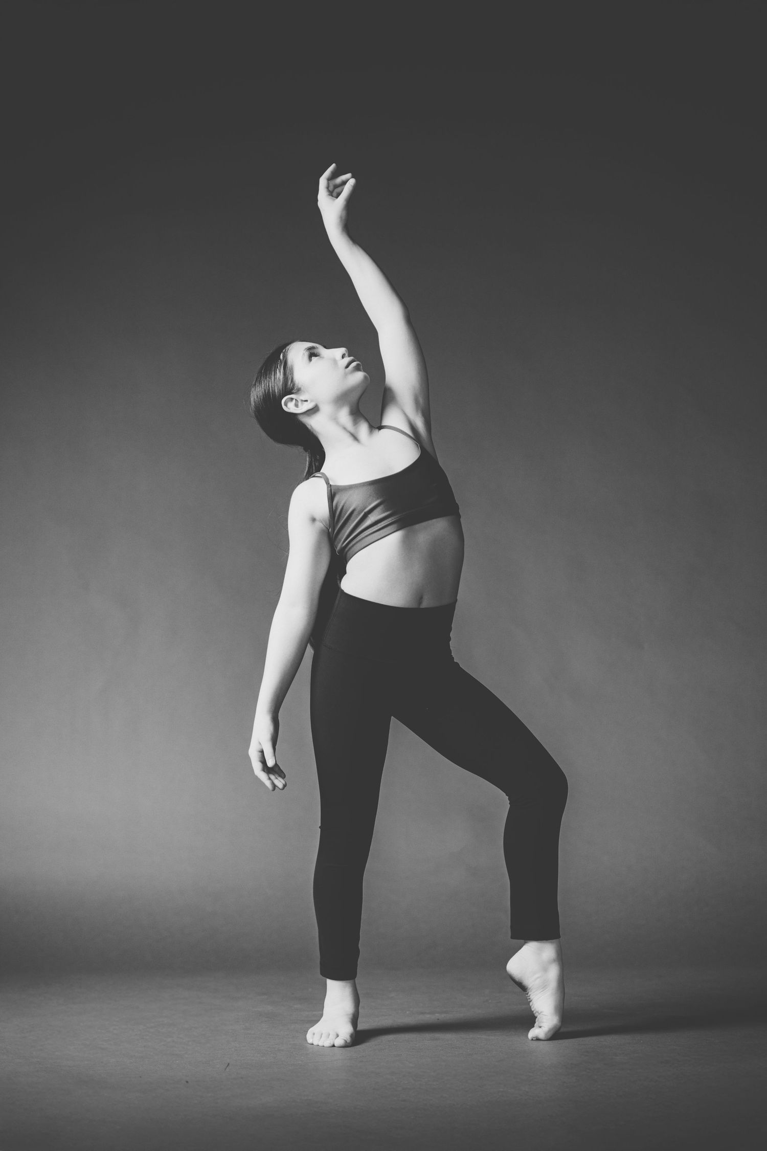 Black and white dance photography series showing graceful movement and poses in dramatic studio lighting.