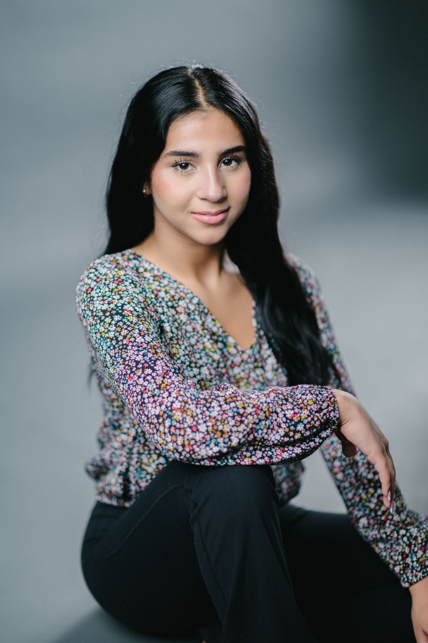 A portrait series showing a person in a sparkly long-sleeved black dress posing against a gray studio backdrop.