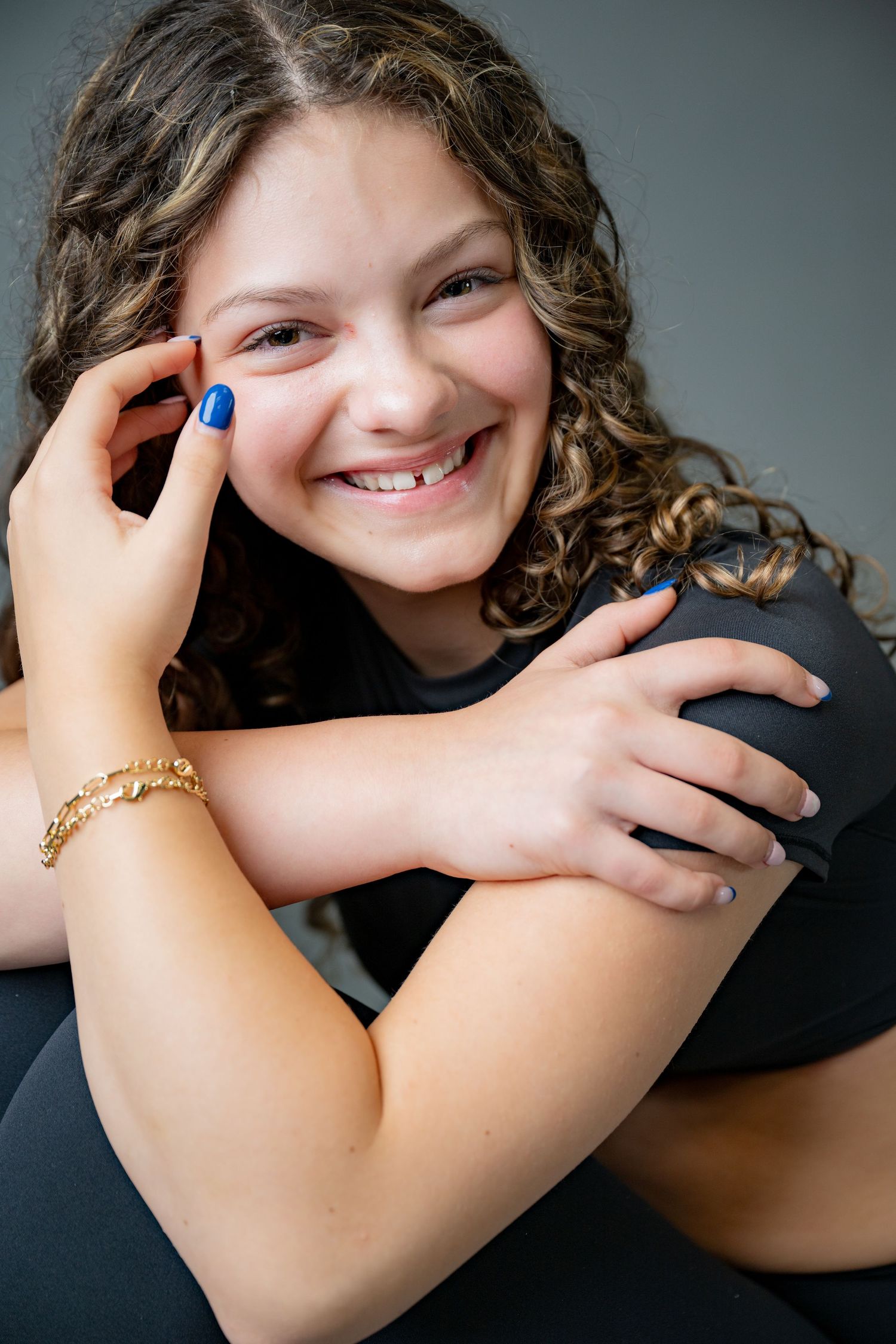 A series of four close-up photos showing hands wearing a gold bracelet against a dark background.