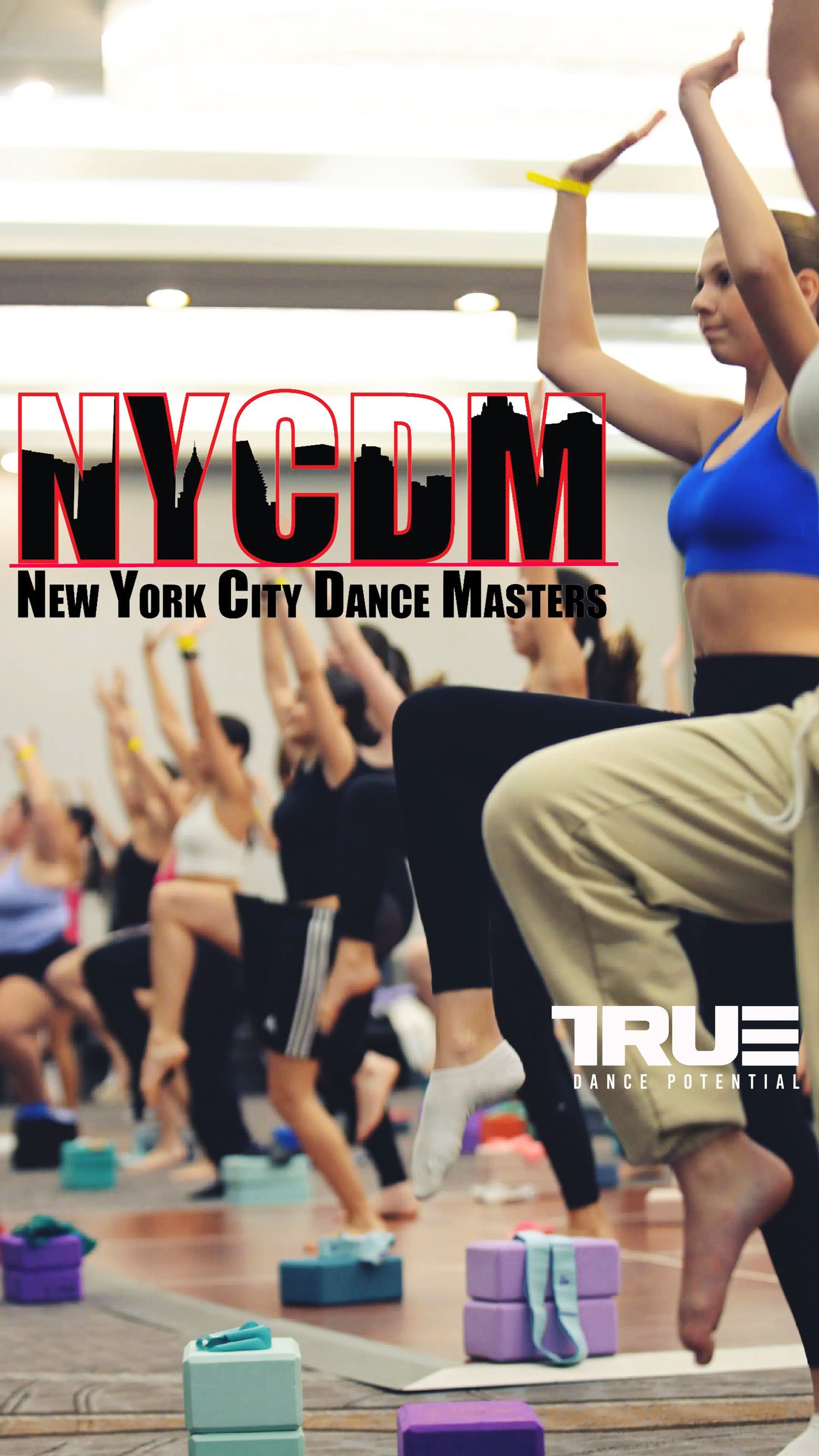 Dancers in a studio practicing yoga-inspired dance moves with colorful foam blocks on wooden floors during class.