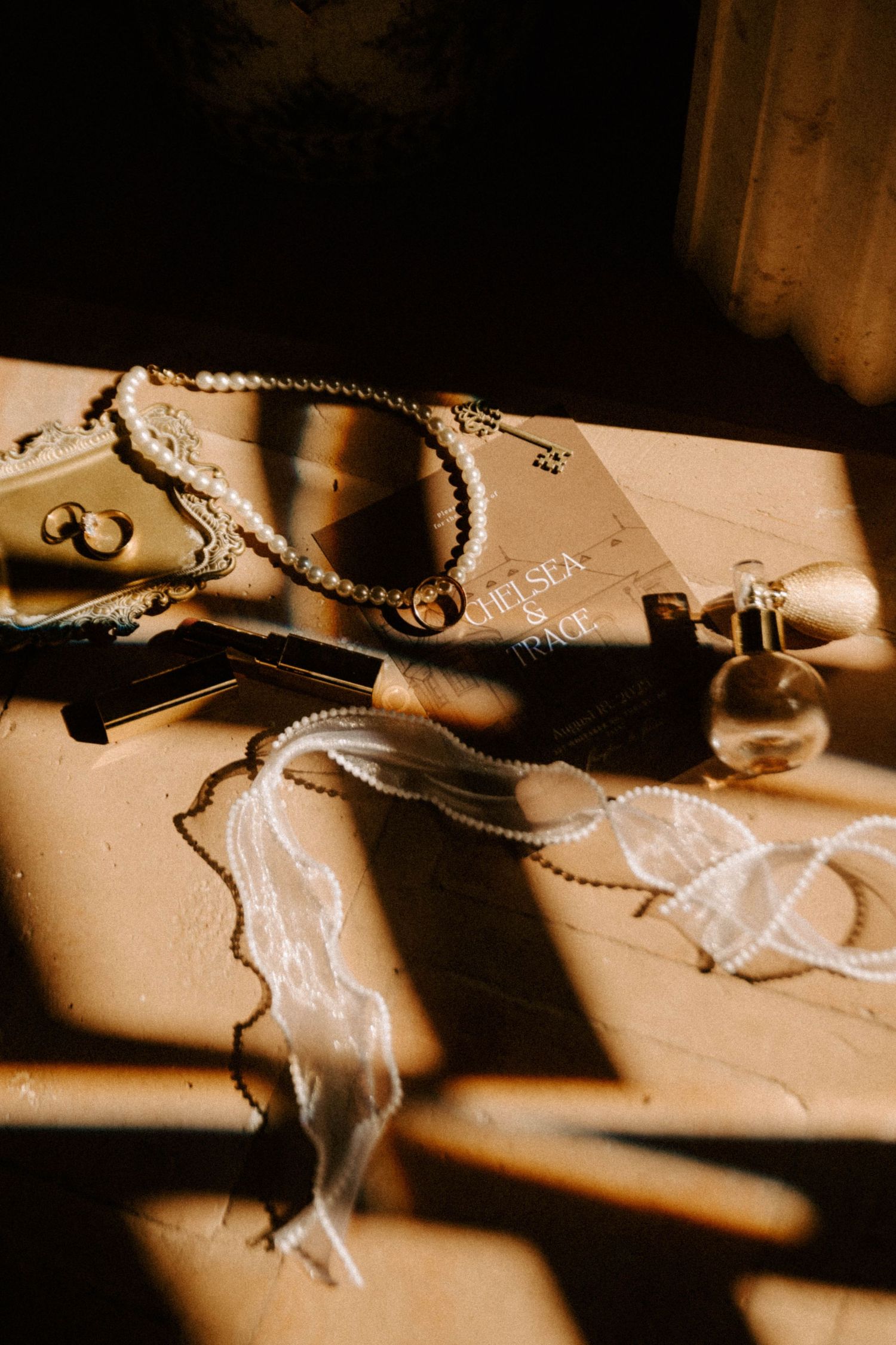 Artistic sepia-toned photo series showing a necklace with pearls casting dramatic shadows on a light surface.