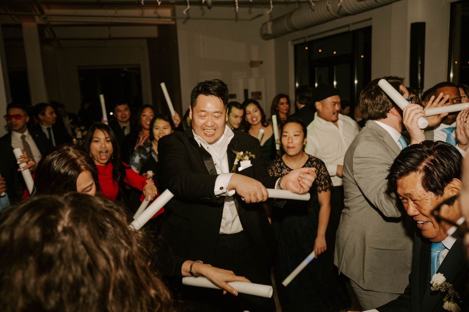 A lively dance floor filled with people enjoying a party or celebration with dynamic movement and energy.