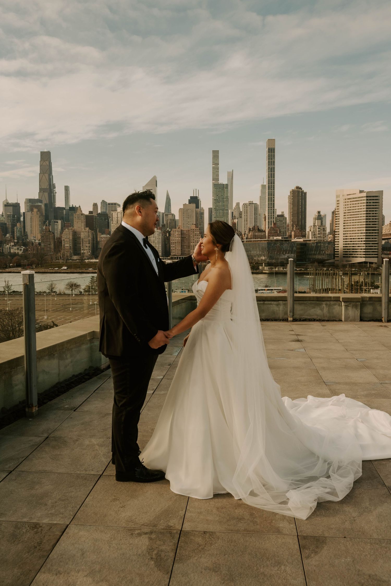 A romantic wedding photoshoot on a rooftop with the New York City skyline creating a stunning urban backdrop.