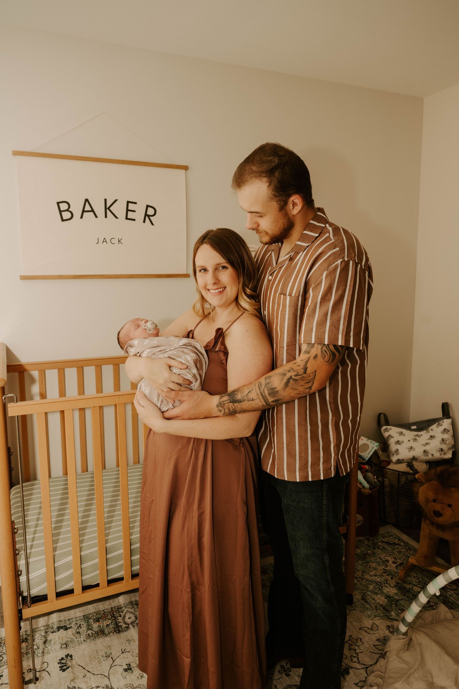 A series of four connected photos showing parents with their newborn baby in a nursery with a wooden crib.