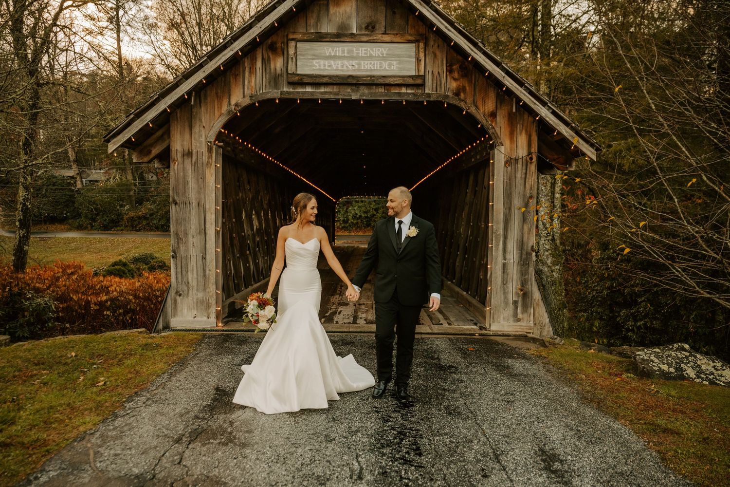 A rustic barn wedding photo shoot captured from multiple angles on a gravel path surrounded by autumn trees.