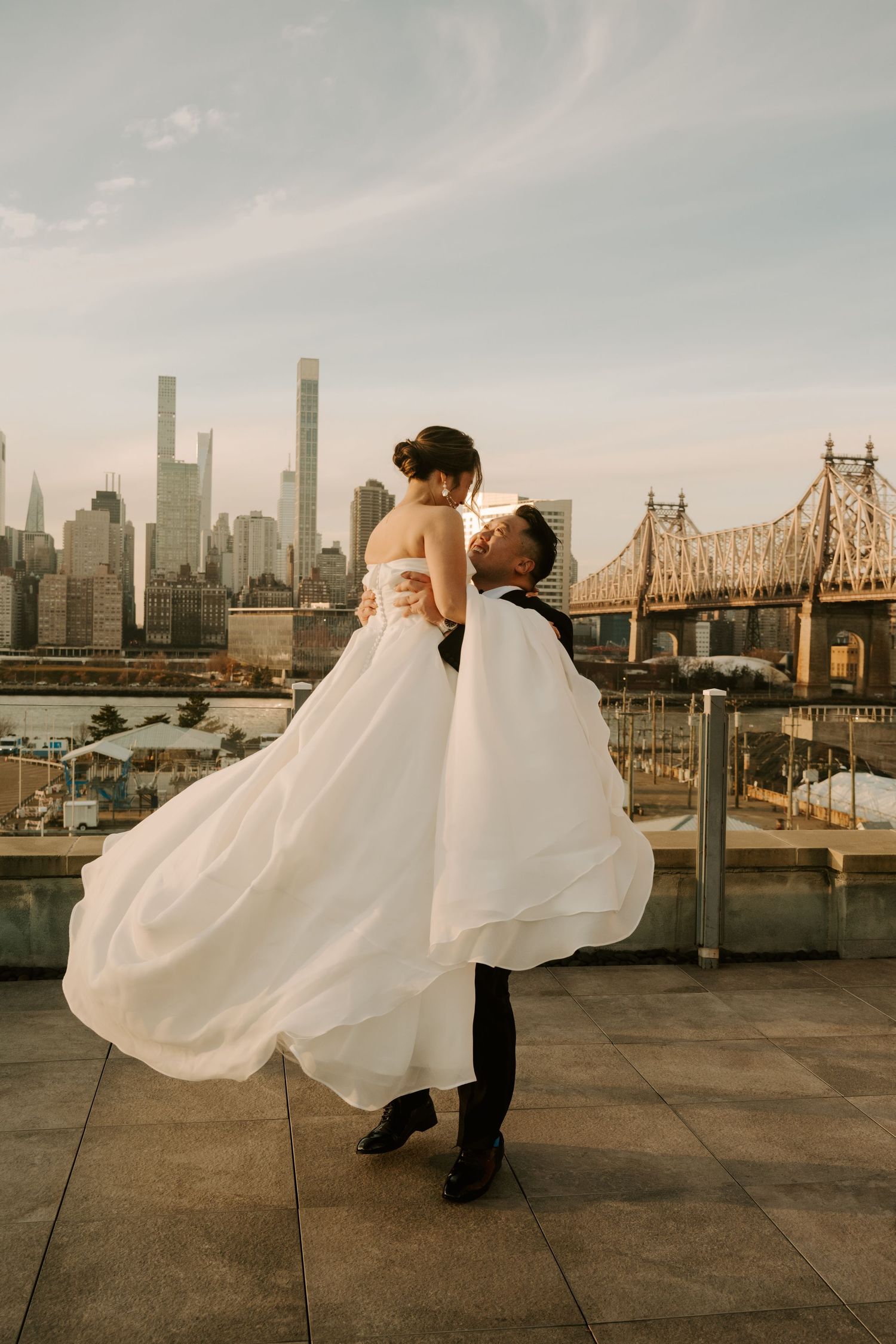 A romantic wedding dance sequence captured against the New York City skyline during sunset.