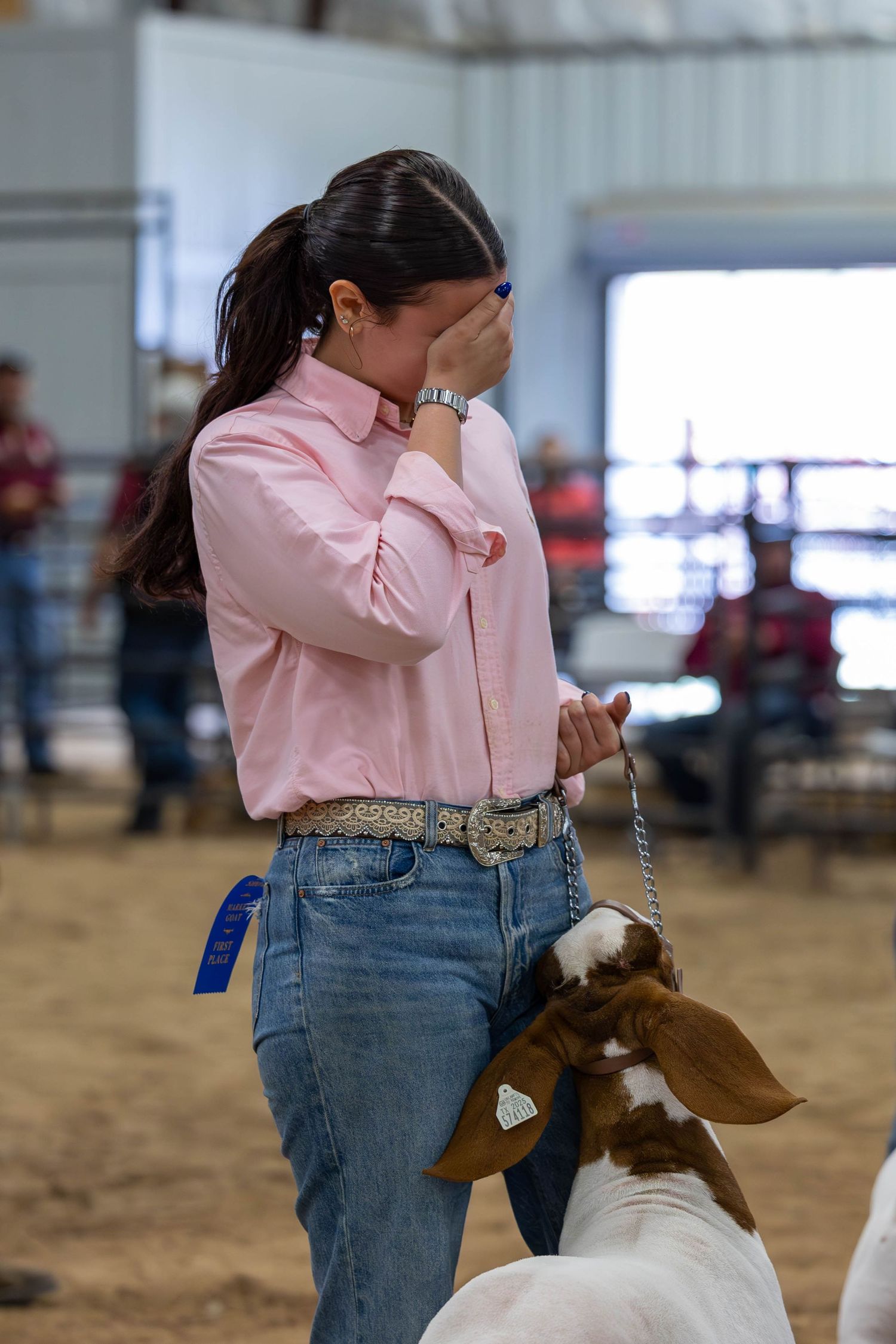 An emotional moment as a competitor stands with their show goat during competition.