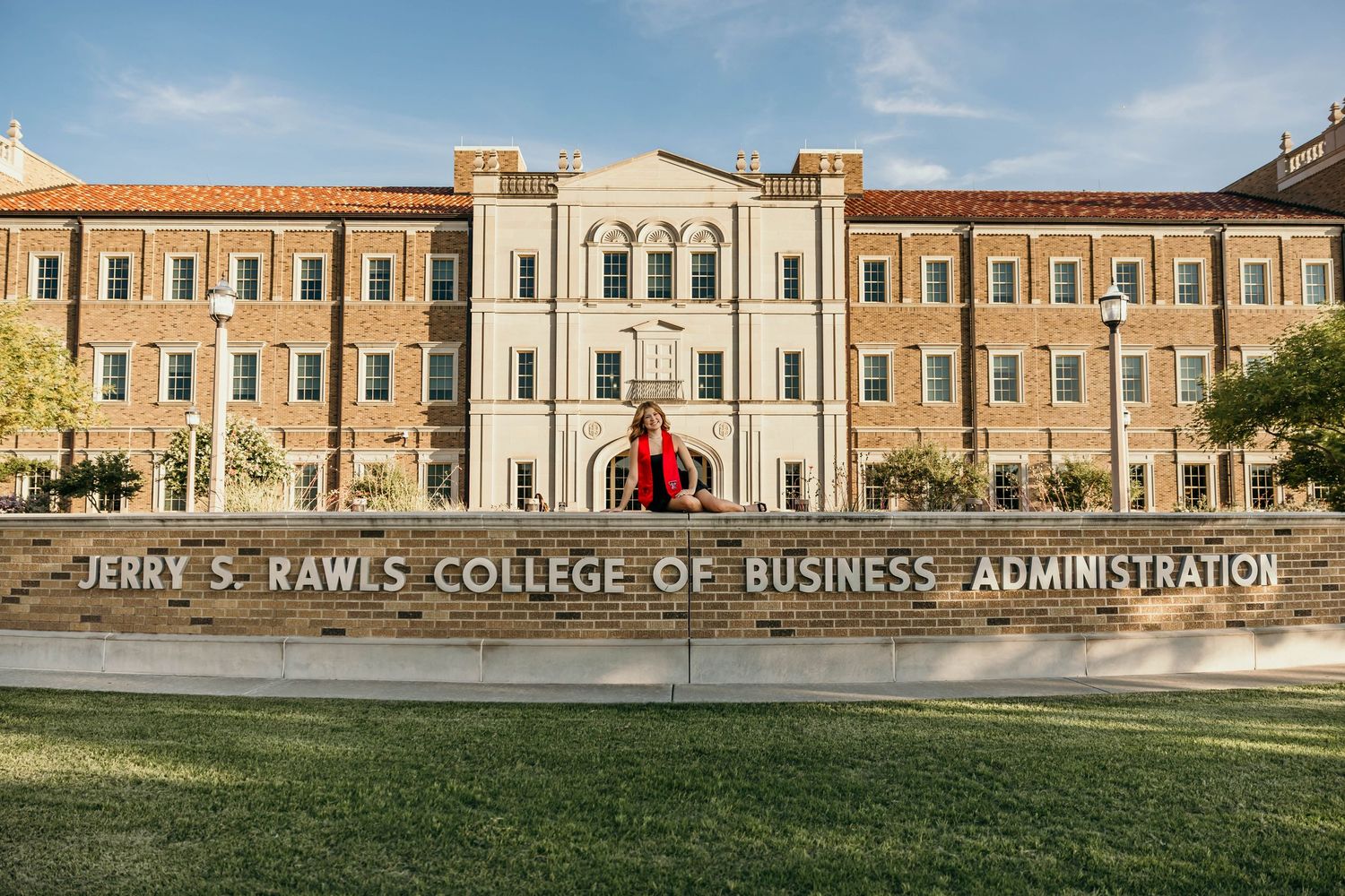 Jerry S. Rawls College of Business Administration building on a sunny day with green lawn in front.