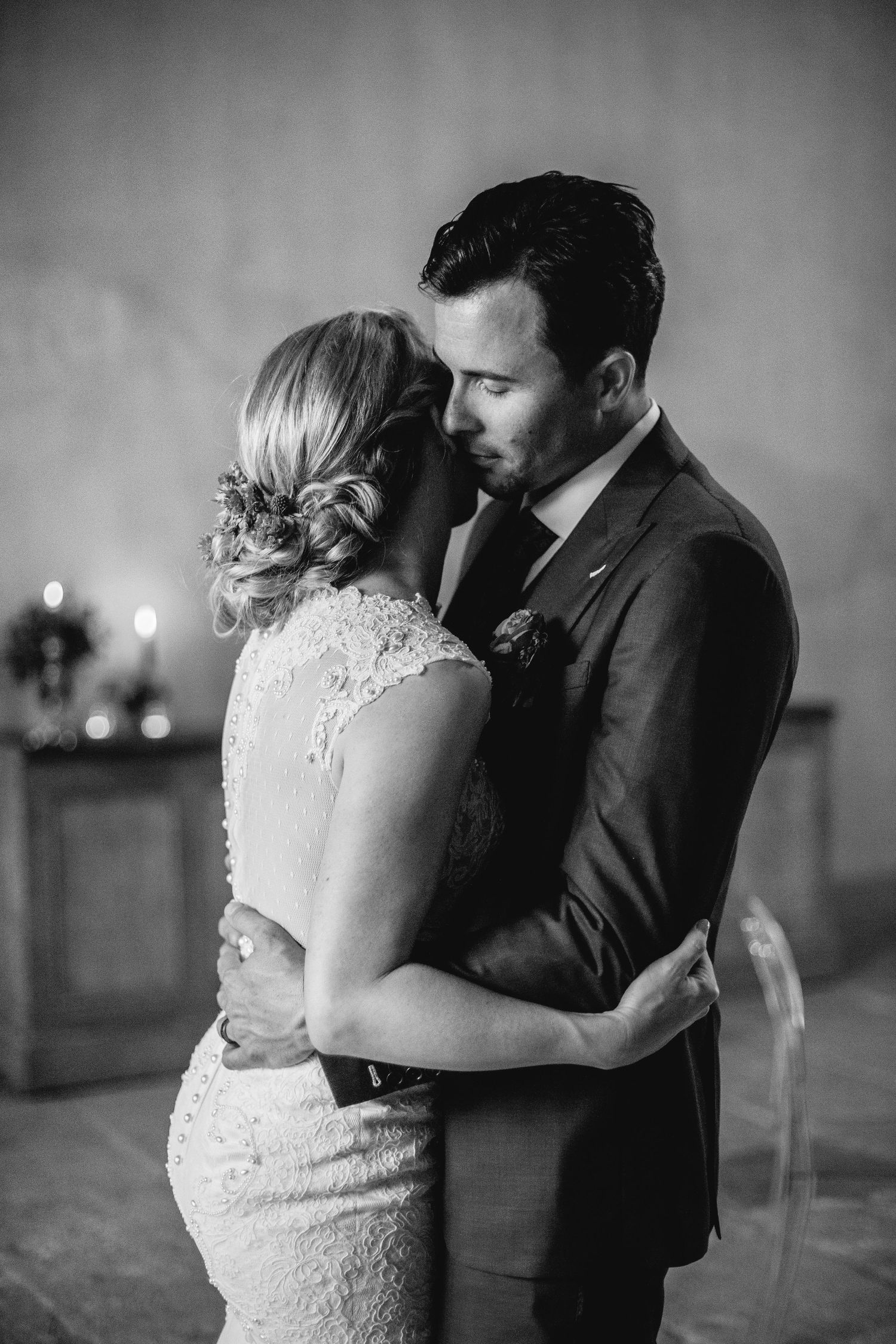 Intimate black and white portrait of newlyweds sharing a tender moment.