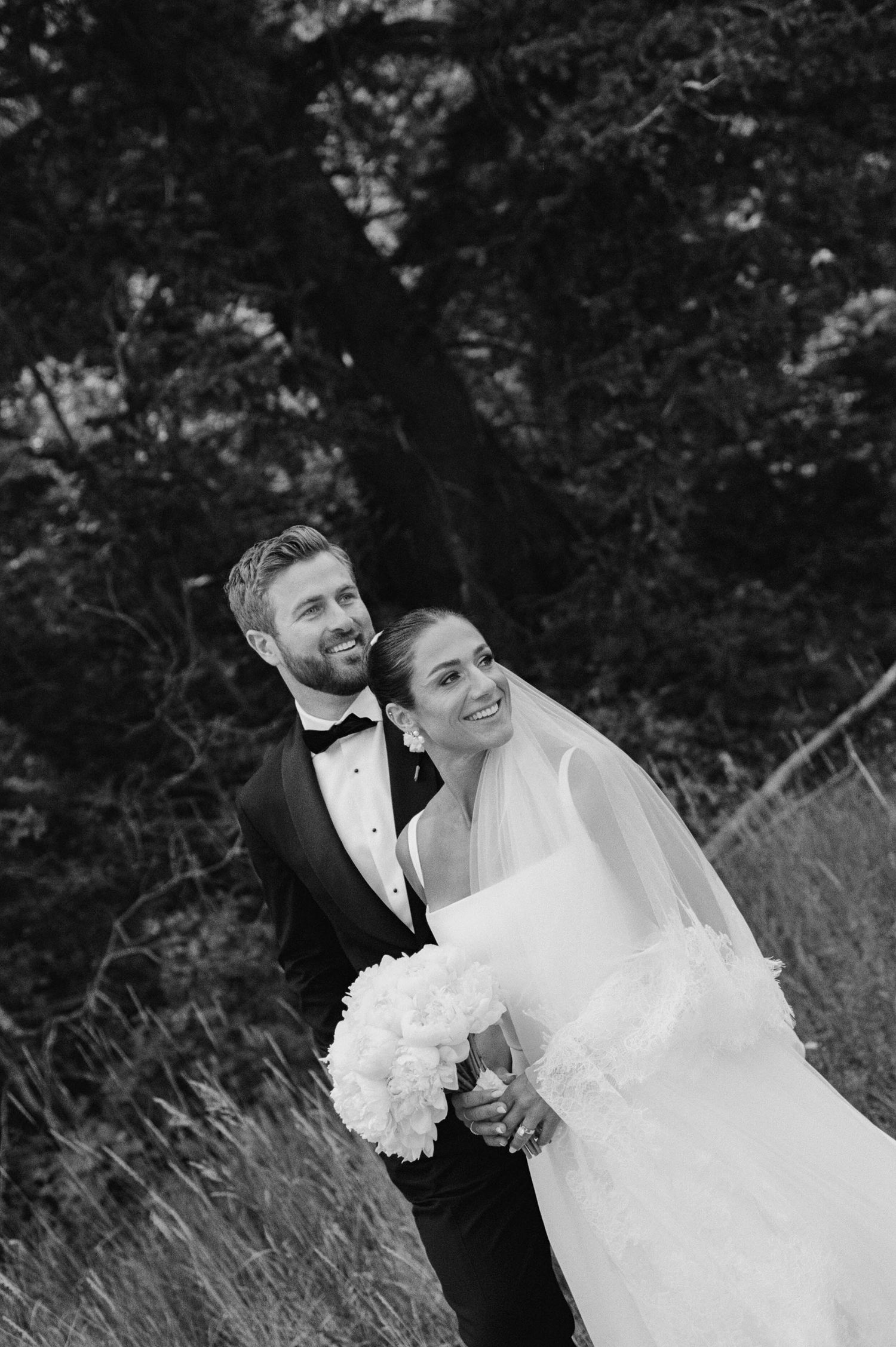 A romantic black and white wedding photo sequence showing tender moments between newlyweds in a natural outdoor setting.