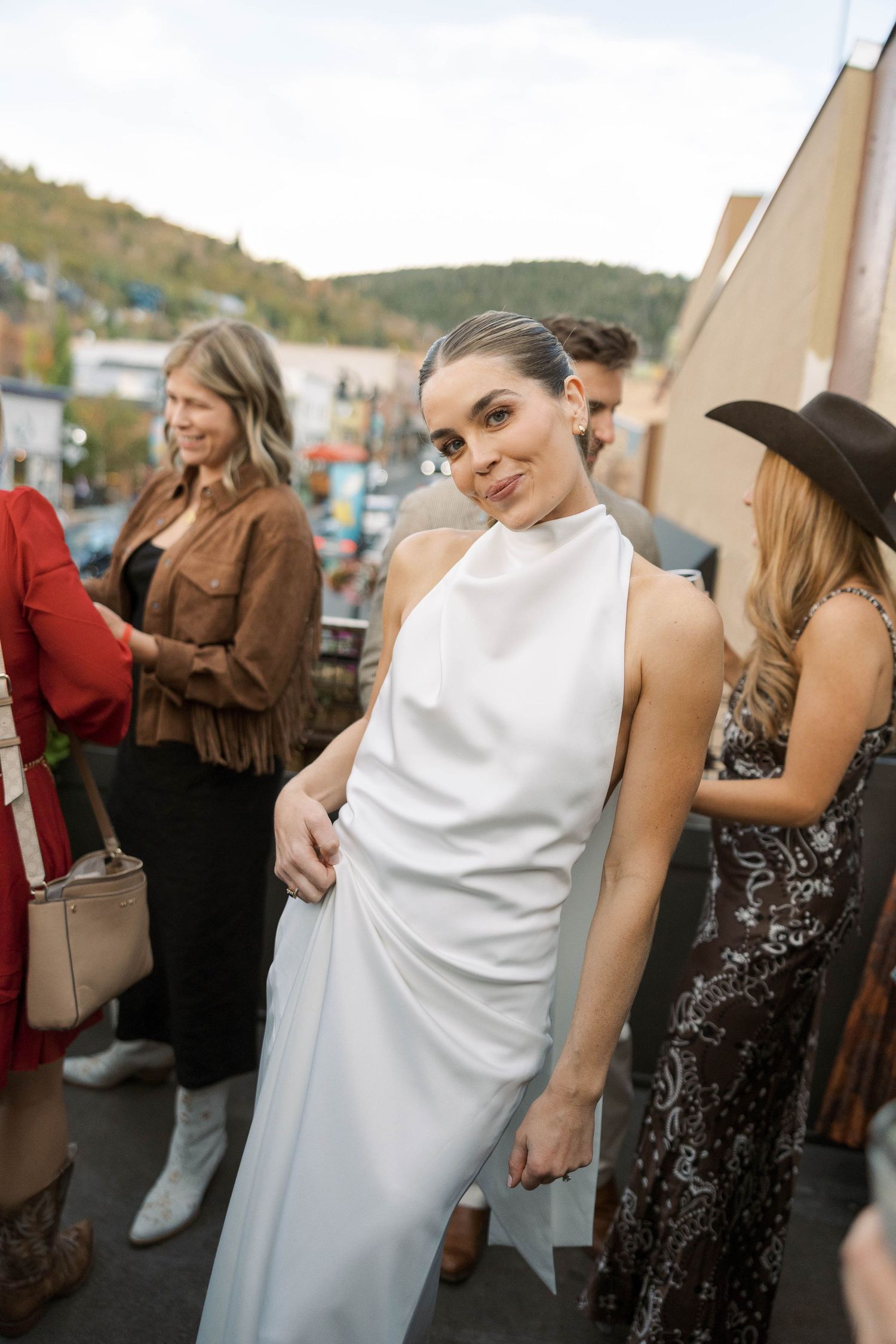 Wedding party guests dance and celebrate together at an outdoor reception.