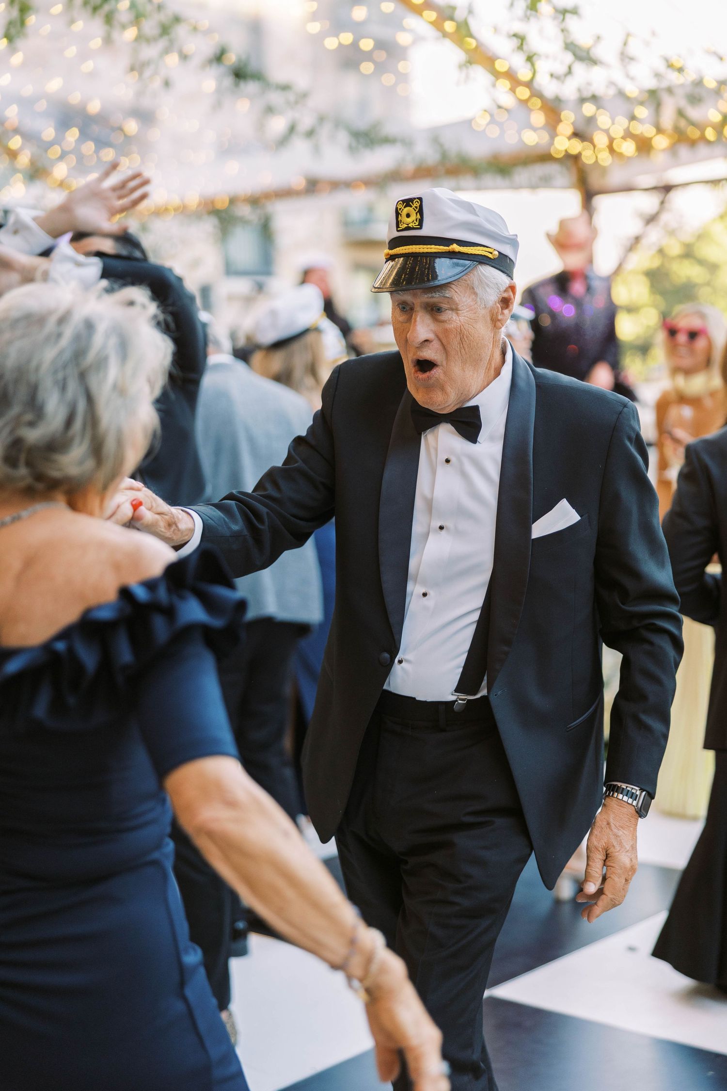 A sequence of photos showing a couple dancing energetically at a formal event in evening attire.