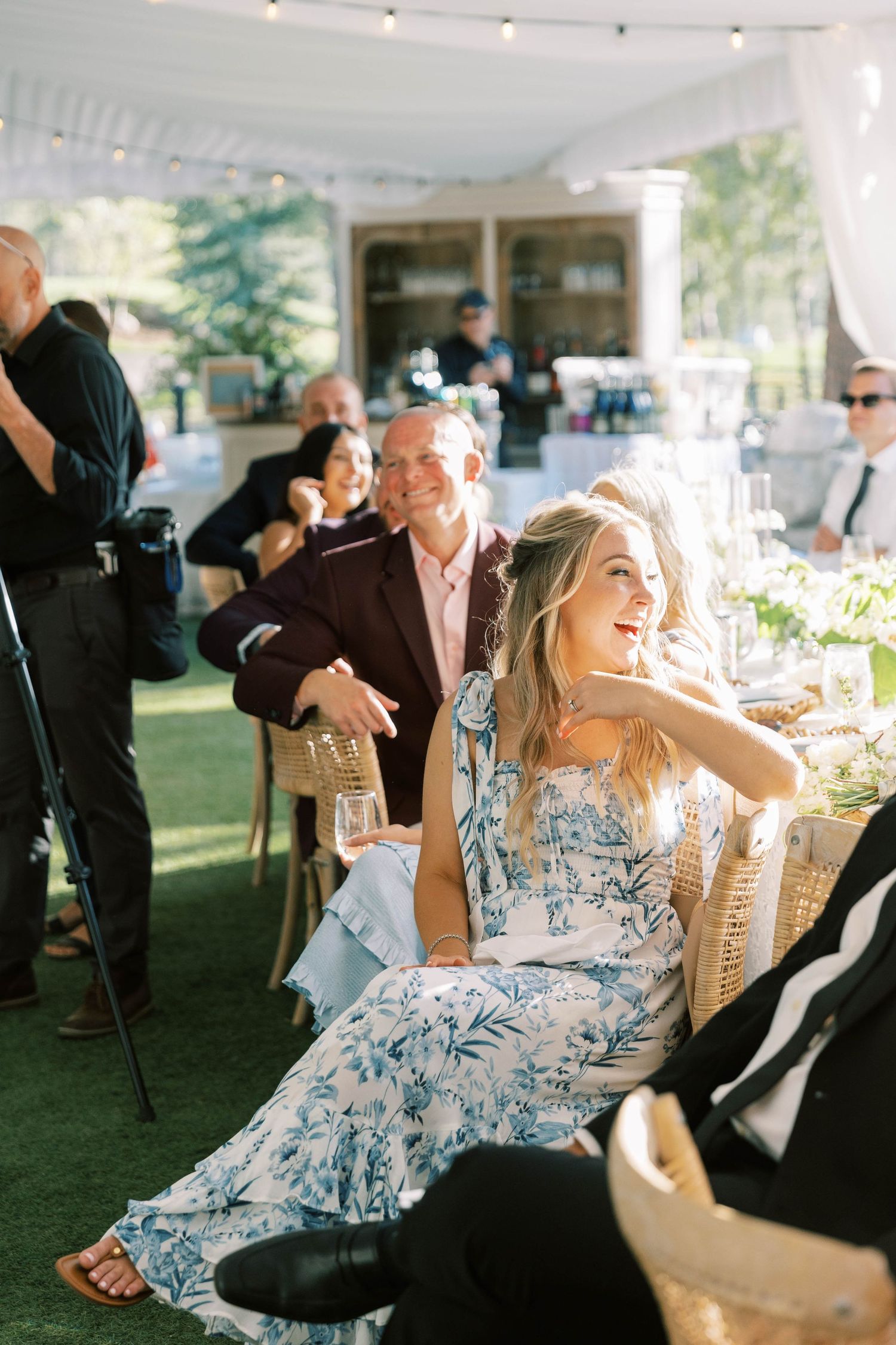 Outdoor wedding reception with guests enjoying festivities on a sunny day.