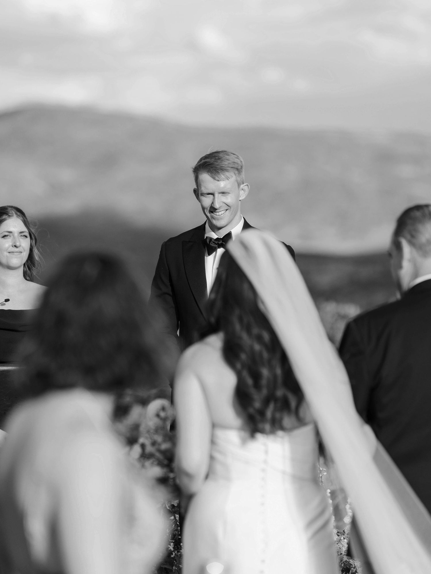 Black and white candid moments from outdoor mountain wedding ceremony.