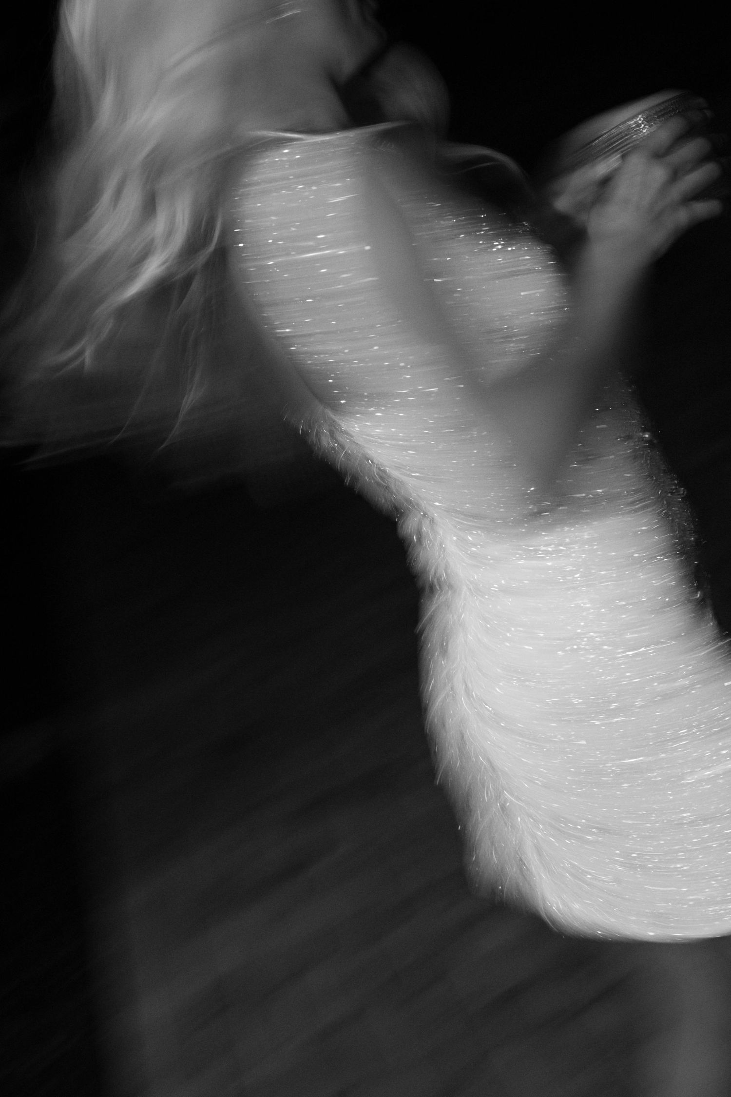 Artistic black and white portrait sequence showing ethereal motion blur and dramatic lighting effects.