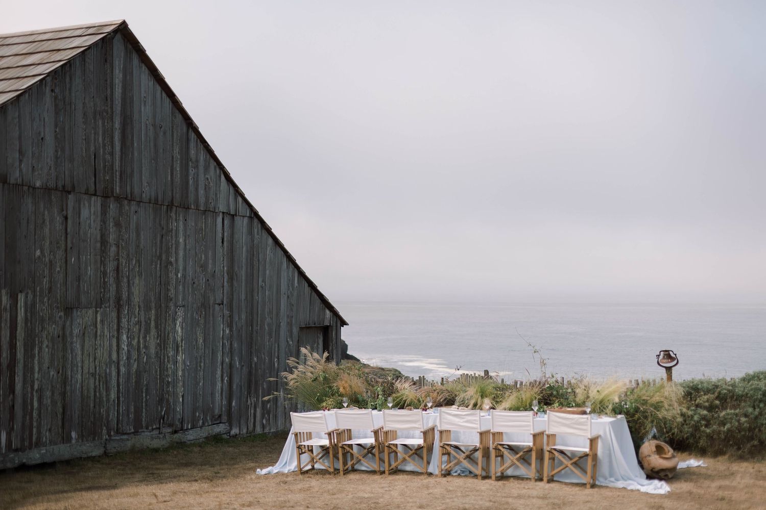 A series of outdoor wedding photos showing a rustic barn venue with elegant decor and scenic countryside views.