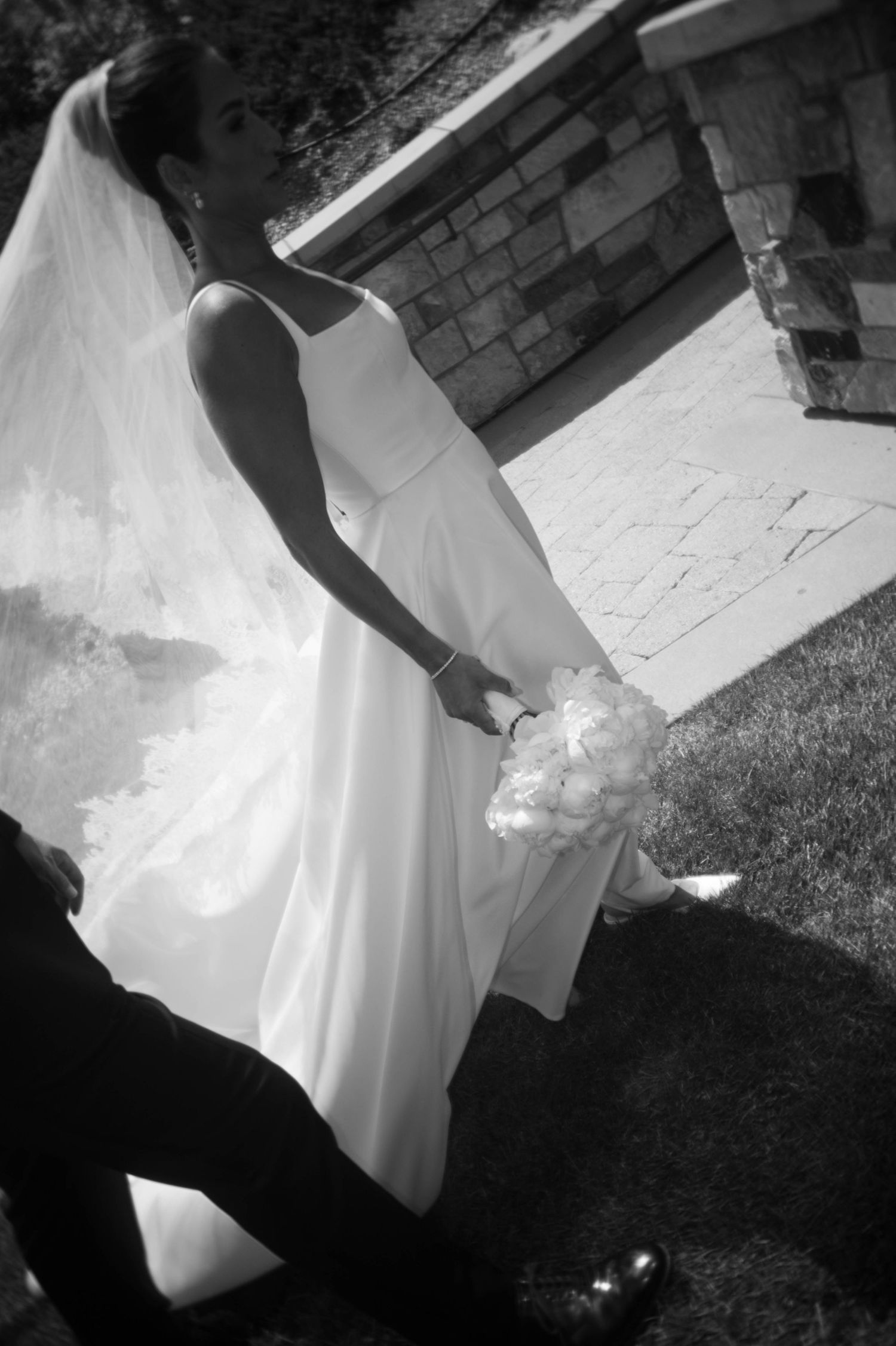 Black and white wedding dress photos showing elegant movement and flowing fabric details.