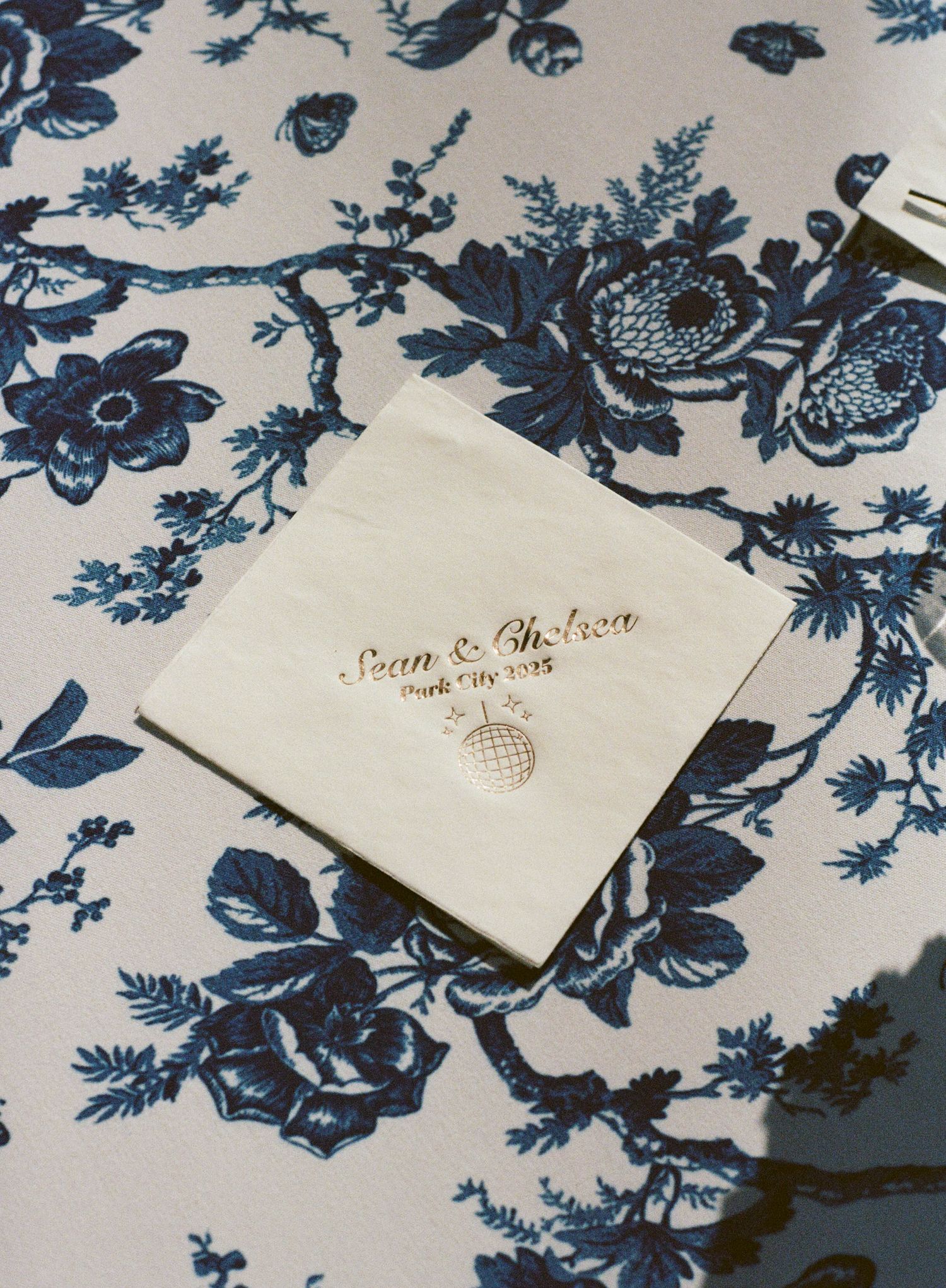 Navy blue floral pattern design elements with vintage style paper details and text.