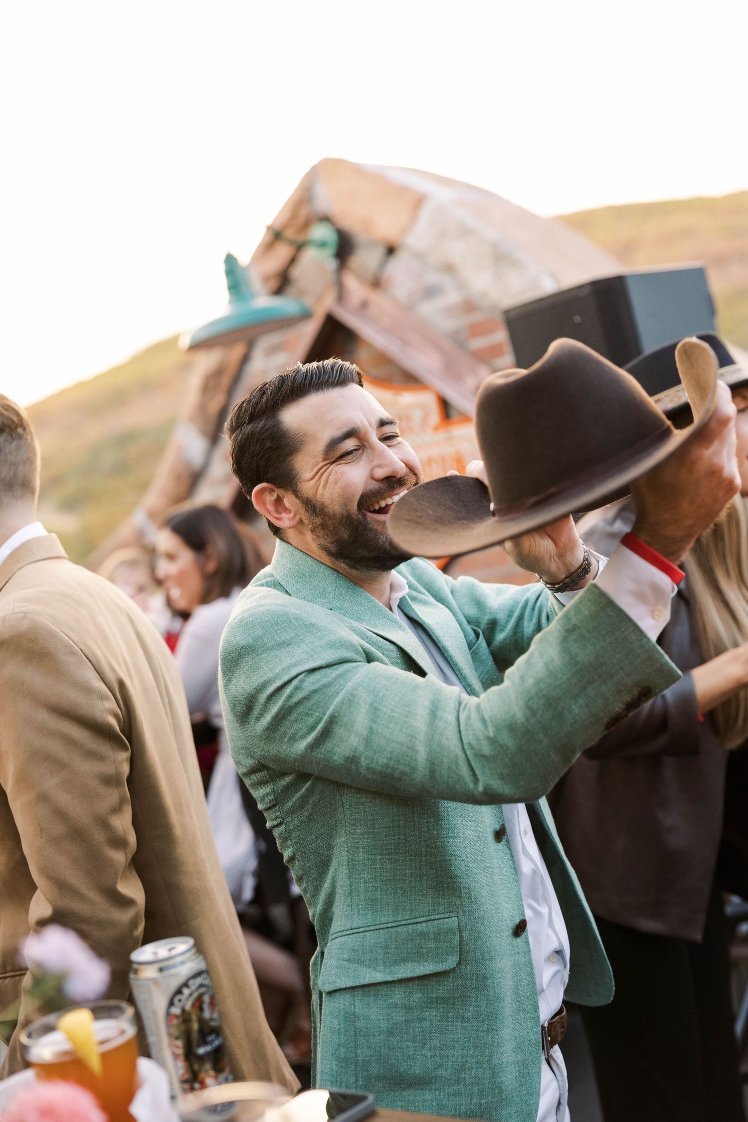 Wedding guests enjoying drinks and celebrations at an outdoor reception.