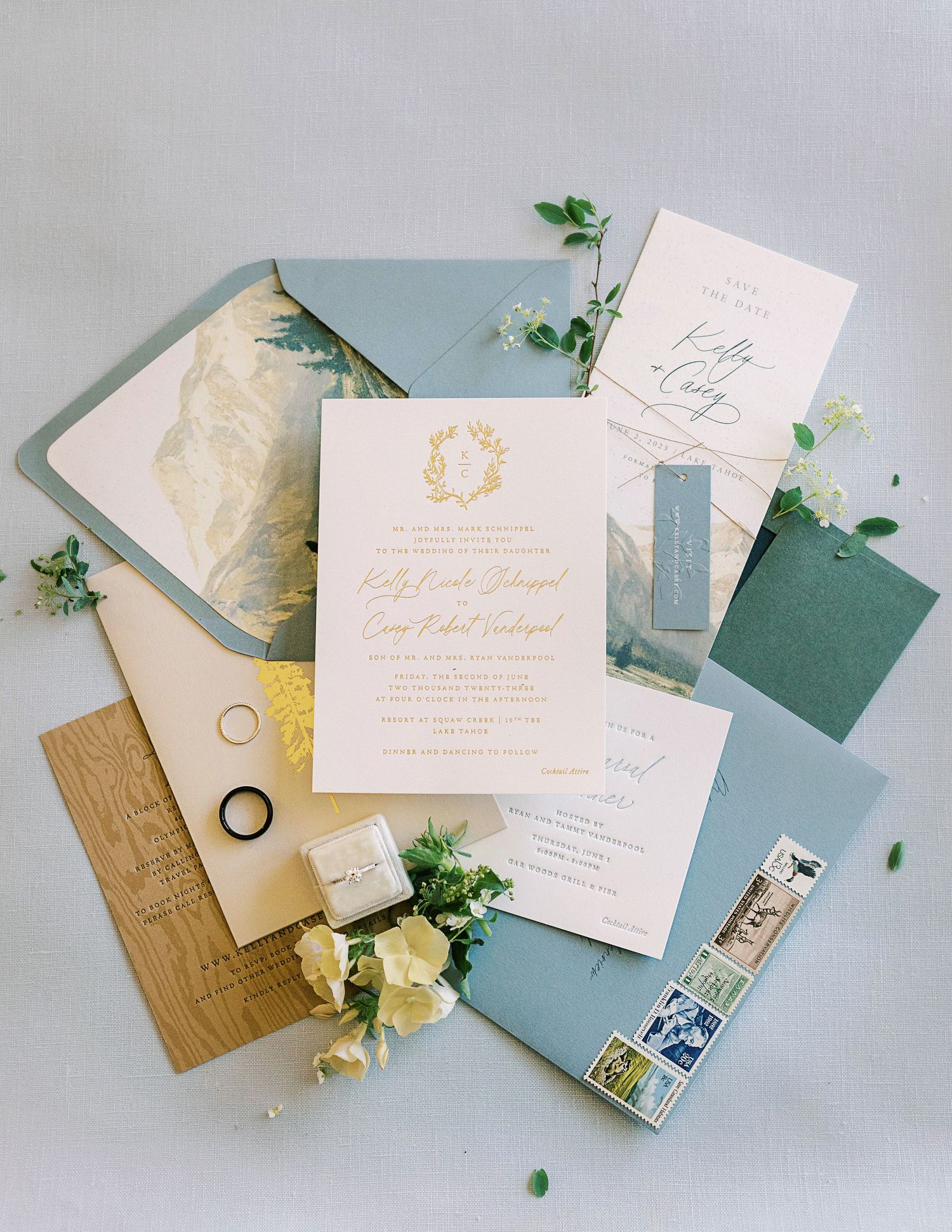 Wedding invitation suite with sage green and gold details including envelopes and botanical elements.