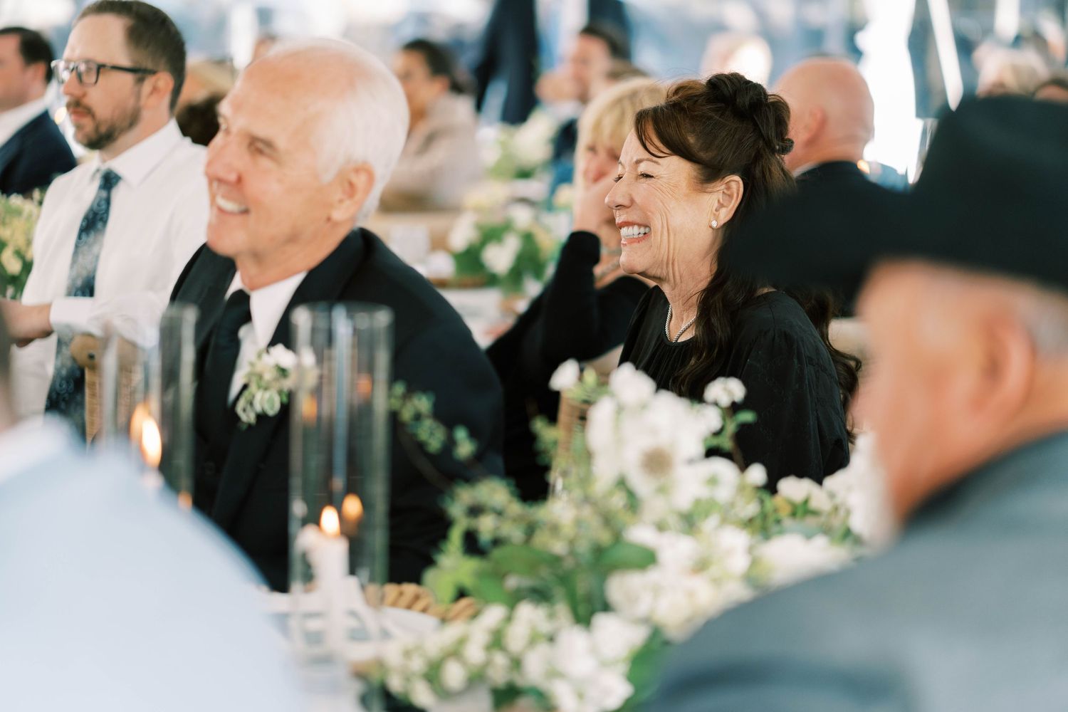 Wedding guests enjoying the reception dinner and speeches at decorated tables.
