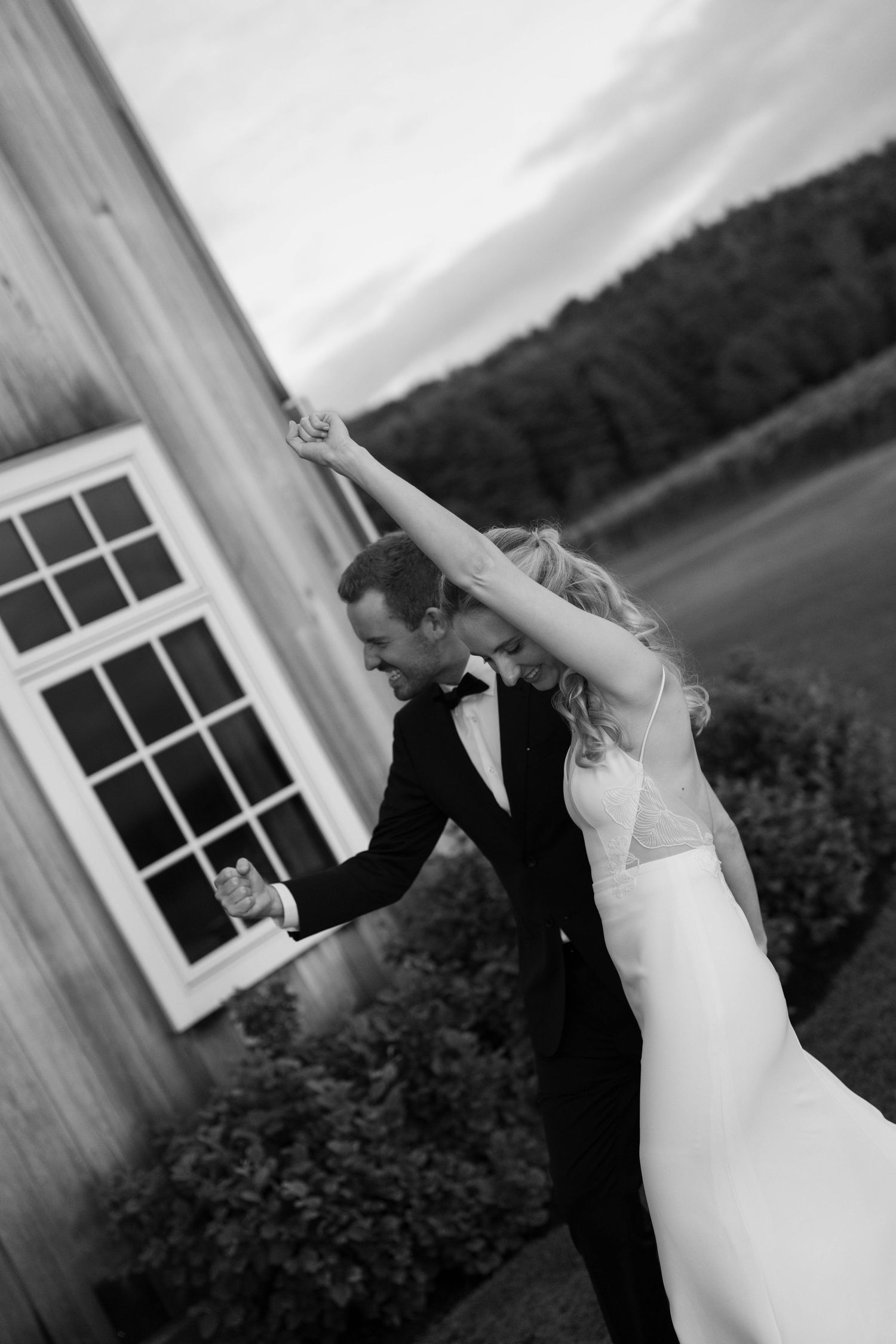 A romantic black and white wedding dance photo series showing couple twirling in sequence against windows and scenery.