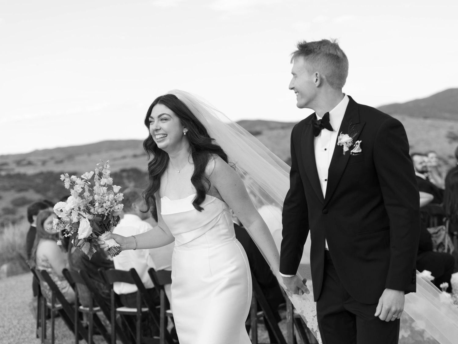 A romantic wedding couple shares joyful moments together in black and white photos against a scenic outdoor backdrop.