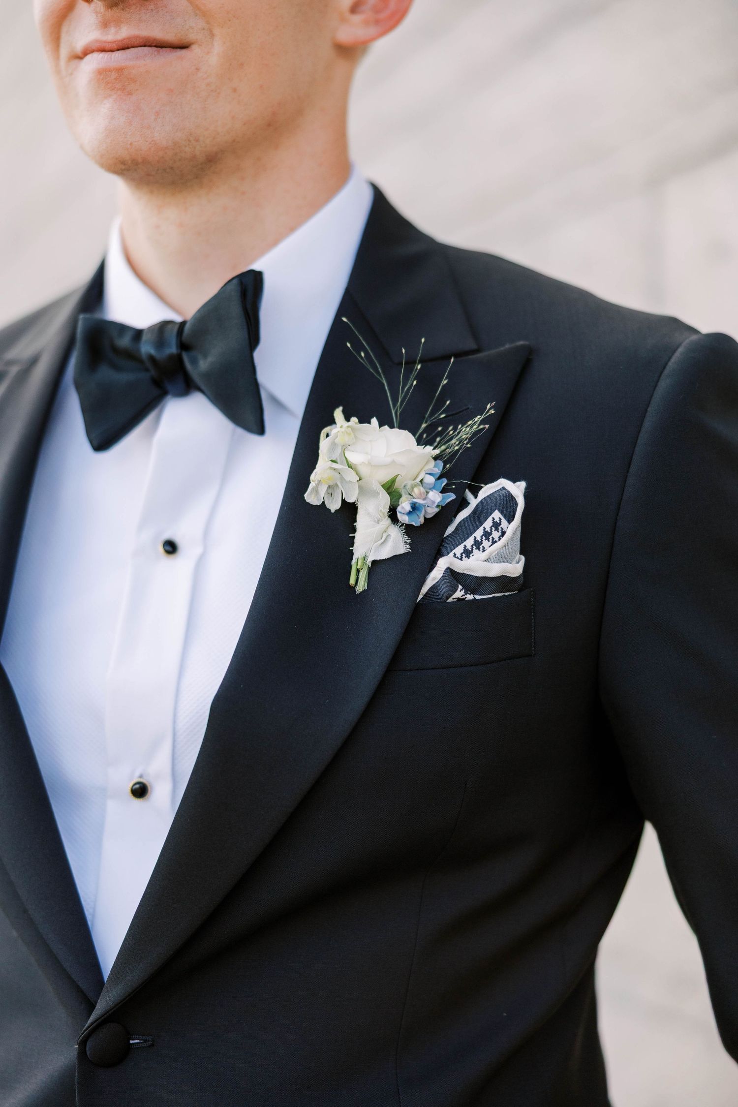 Classic black tuxedo with white boutonniere detail shots.