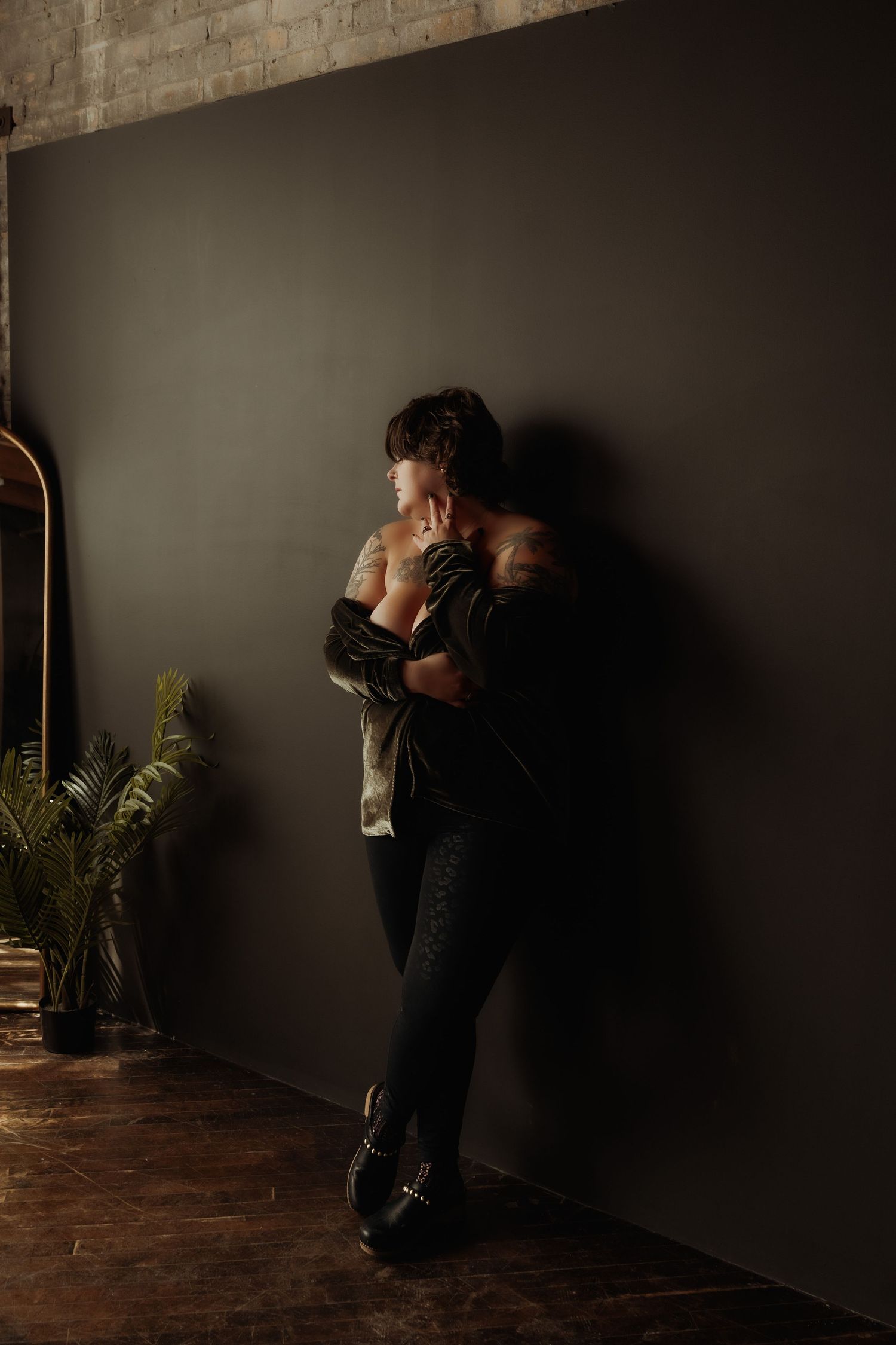 Inclusive boudoir photography session in Grand Rapids featuring a confident woman in a body-positive studio environment