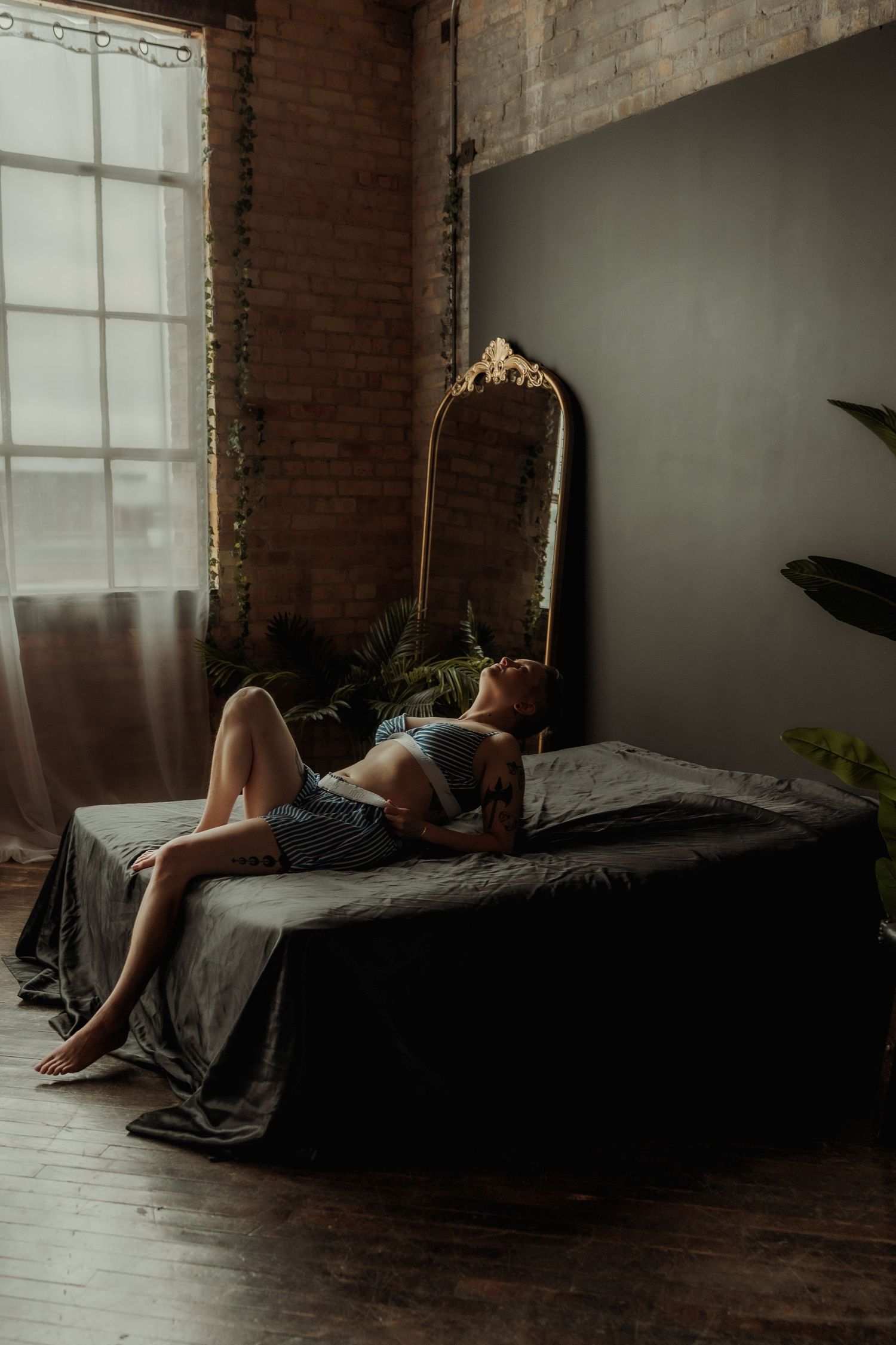Inclusive boudoir photography session in Grand Rapids featuring a confident woman in a body-positive studio environment