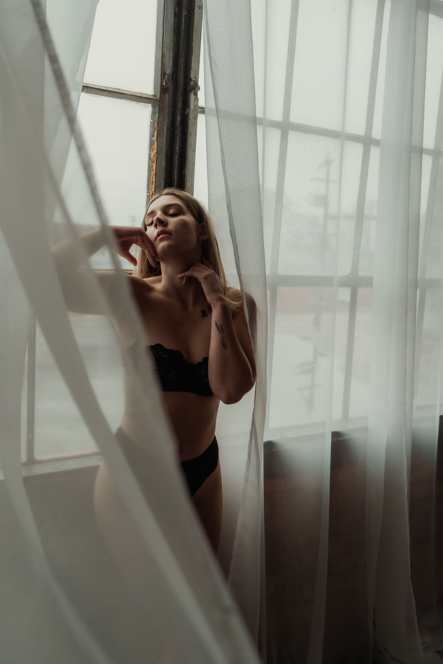 Inclusive boudoir photography session in Grand Rapids featuring a confident woman in a body-positive studio environment