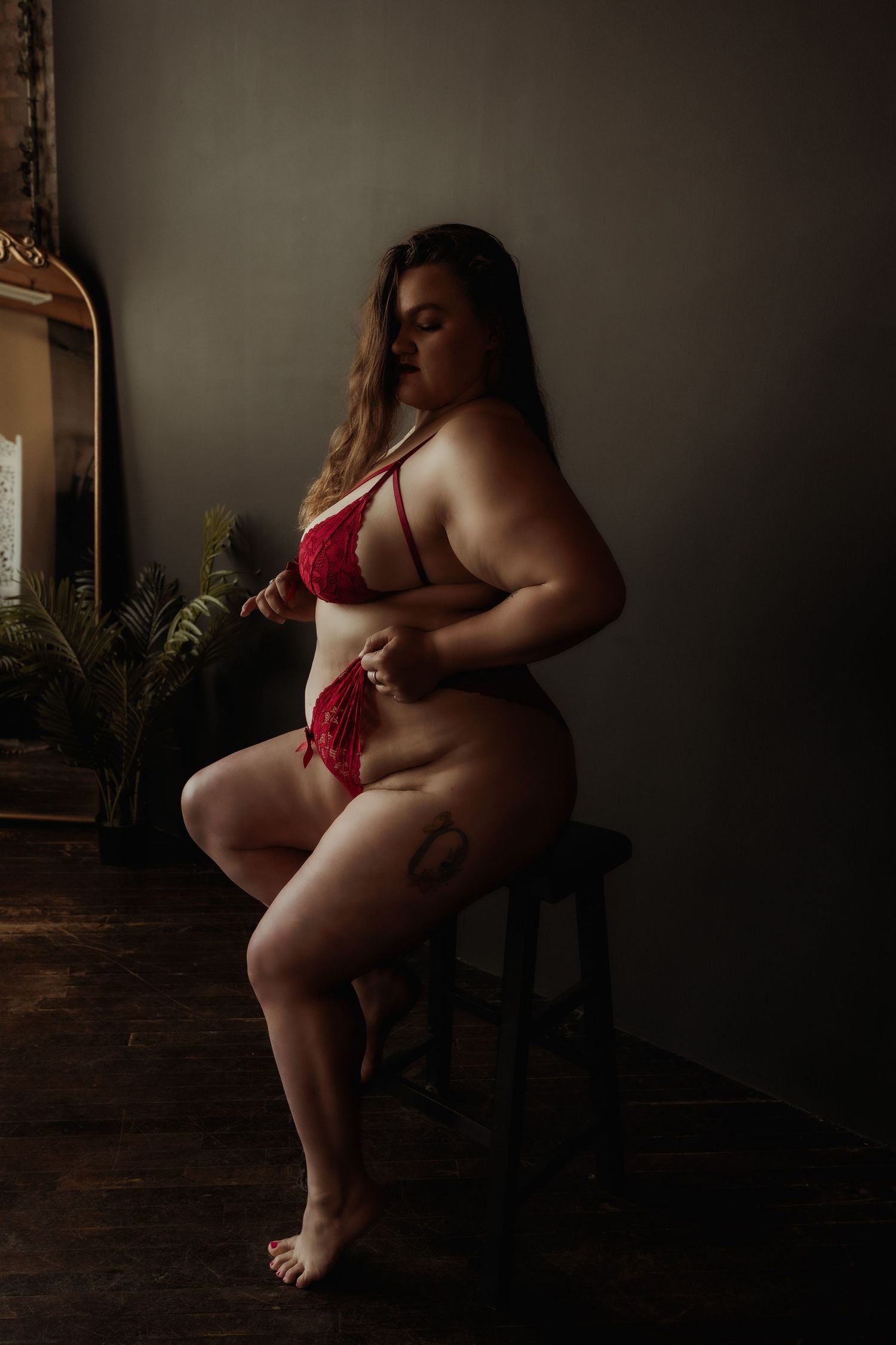 Inclusive boudoir photography session in Grand Rapids featuring a confident woman in a body-positive studio environment